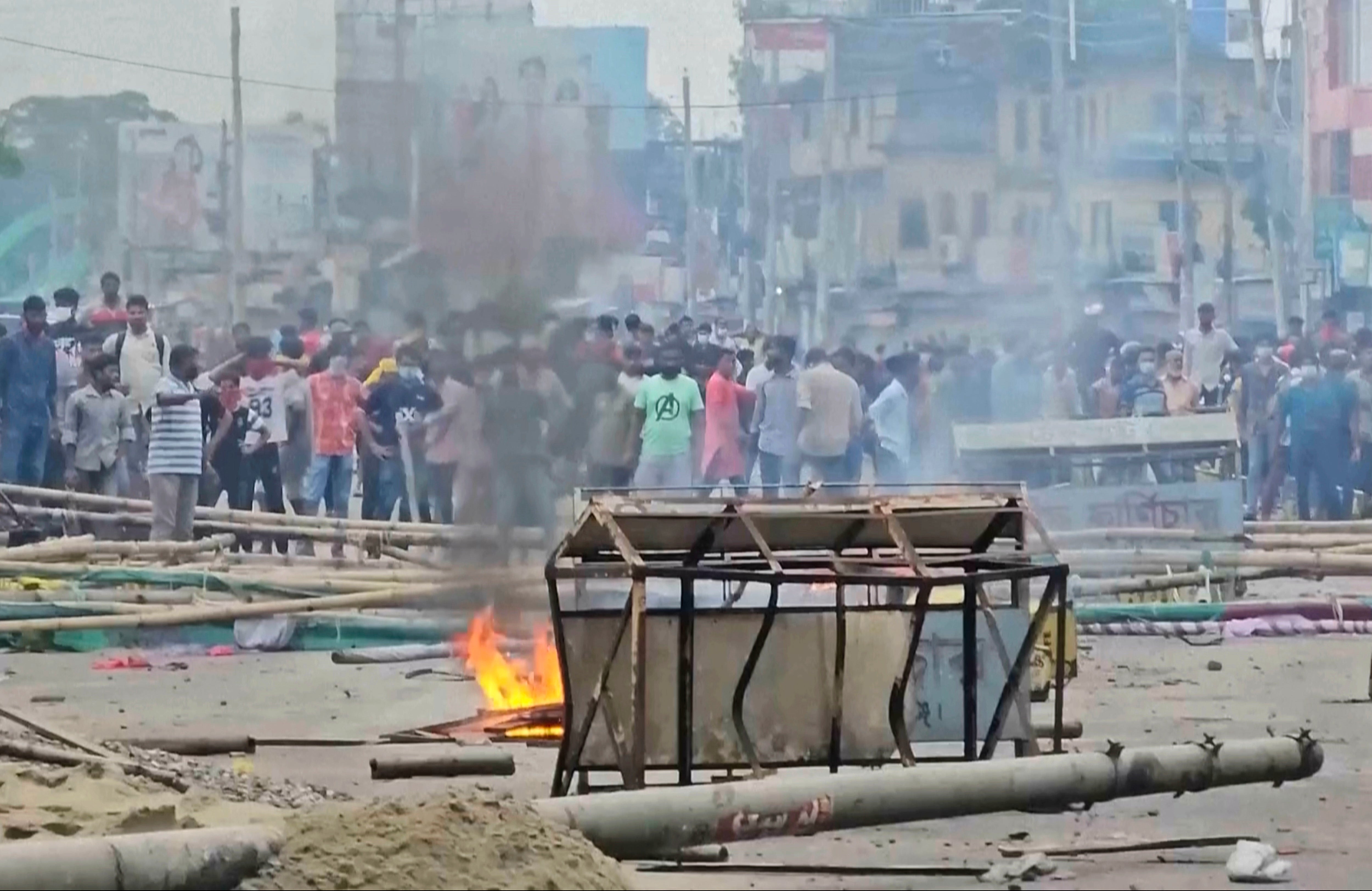 In this image made from a video, supporters of the ousted Prime Minister Sheikh Hasina clash with the police