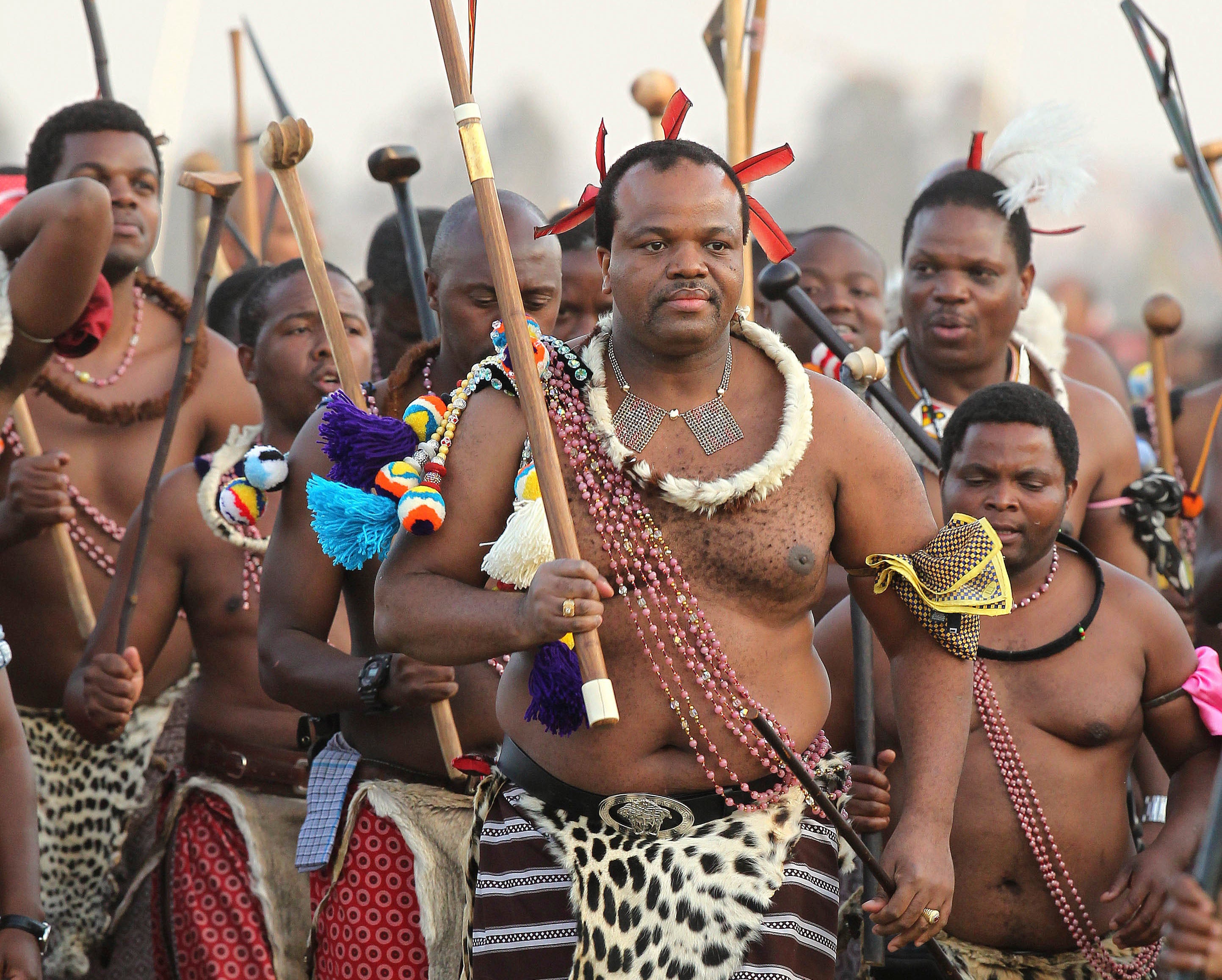 King Mswati III, front, dances during a Reed Dance in Mbabane