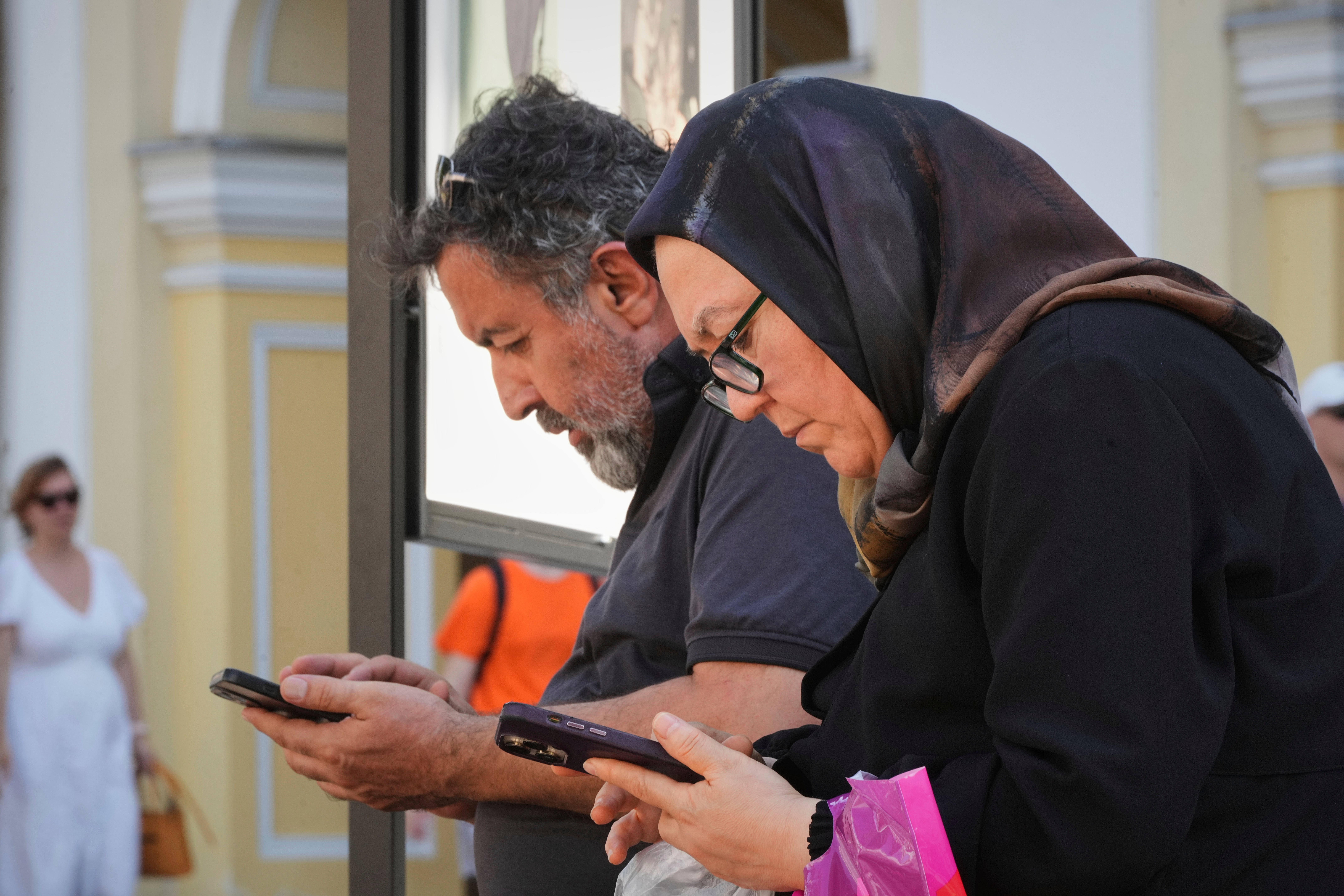 Pedestrians pause to look at their phones in St Petersburg