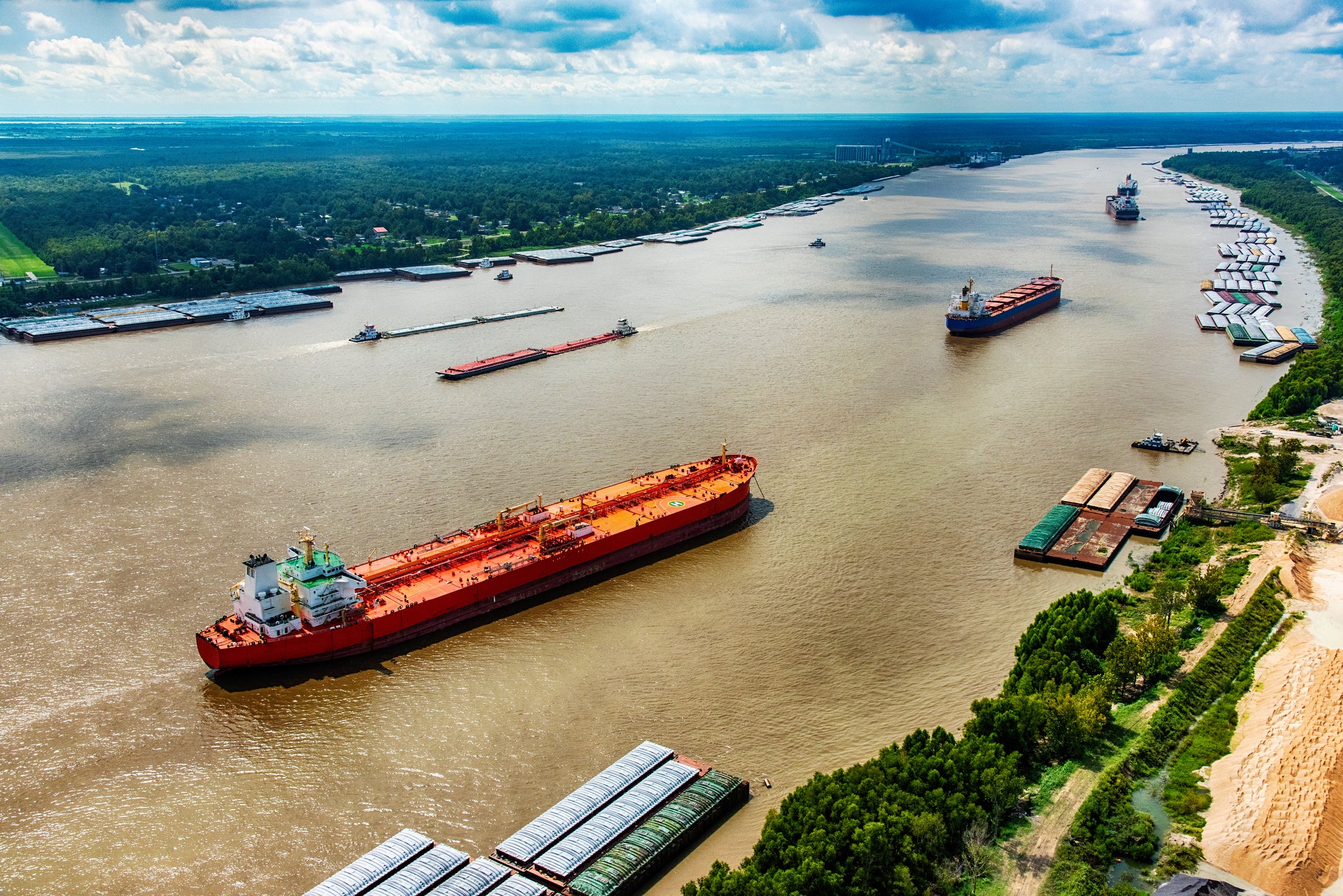 A line of oil tankers transporting fuel to the refineries located along the Mississippi River just north of New Orleans, Louisiana
