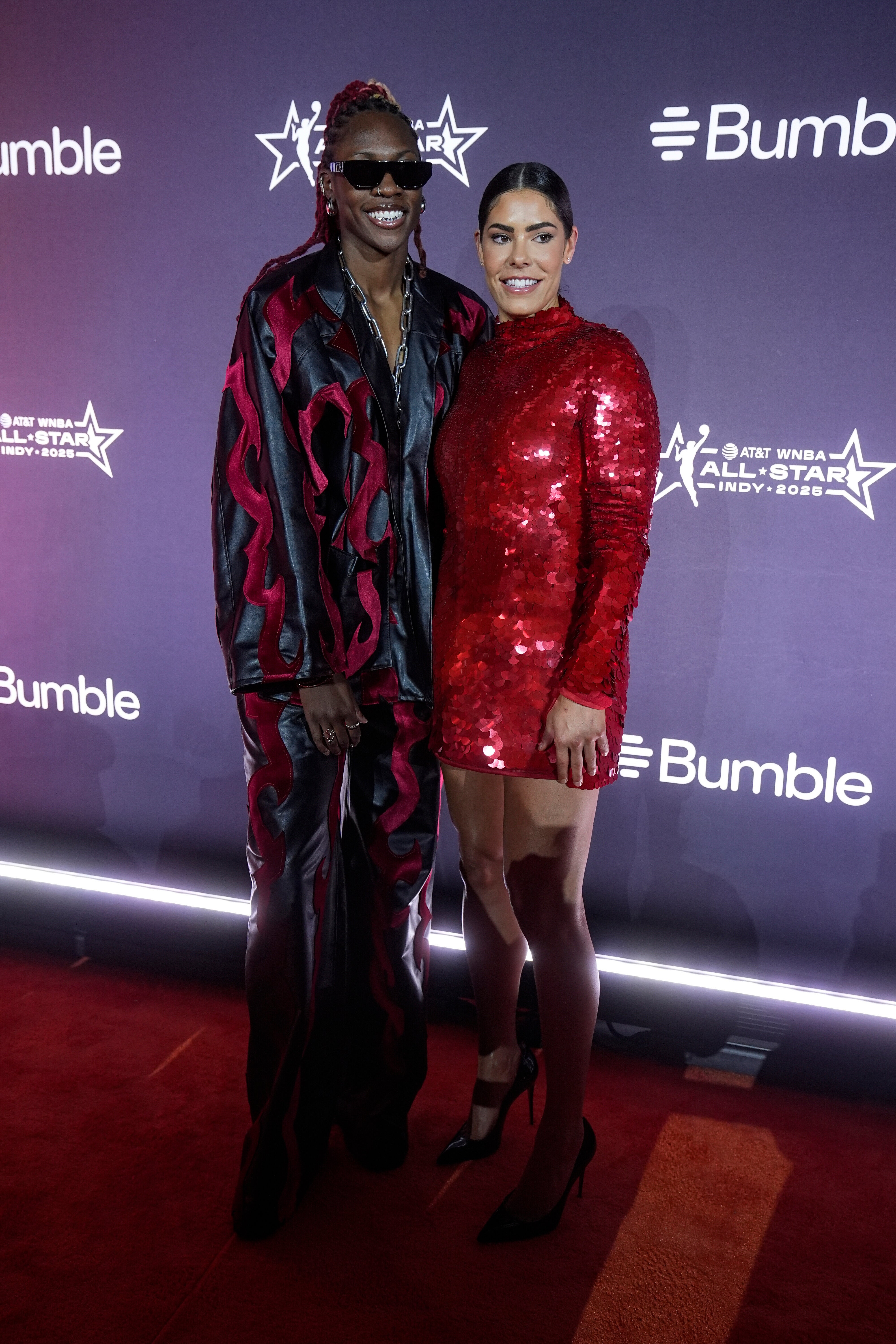 Atlanta Dream's Rhyne Howard and Los Angeles Sparks's Kelsey Plum, from left, pose on the orange carpet for WNBA All Star basketball events