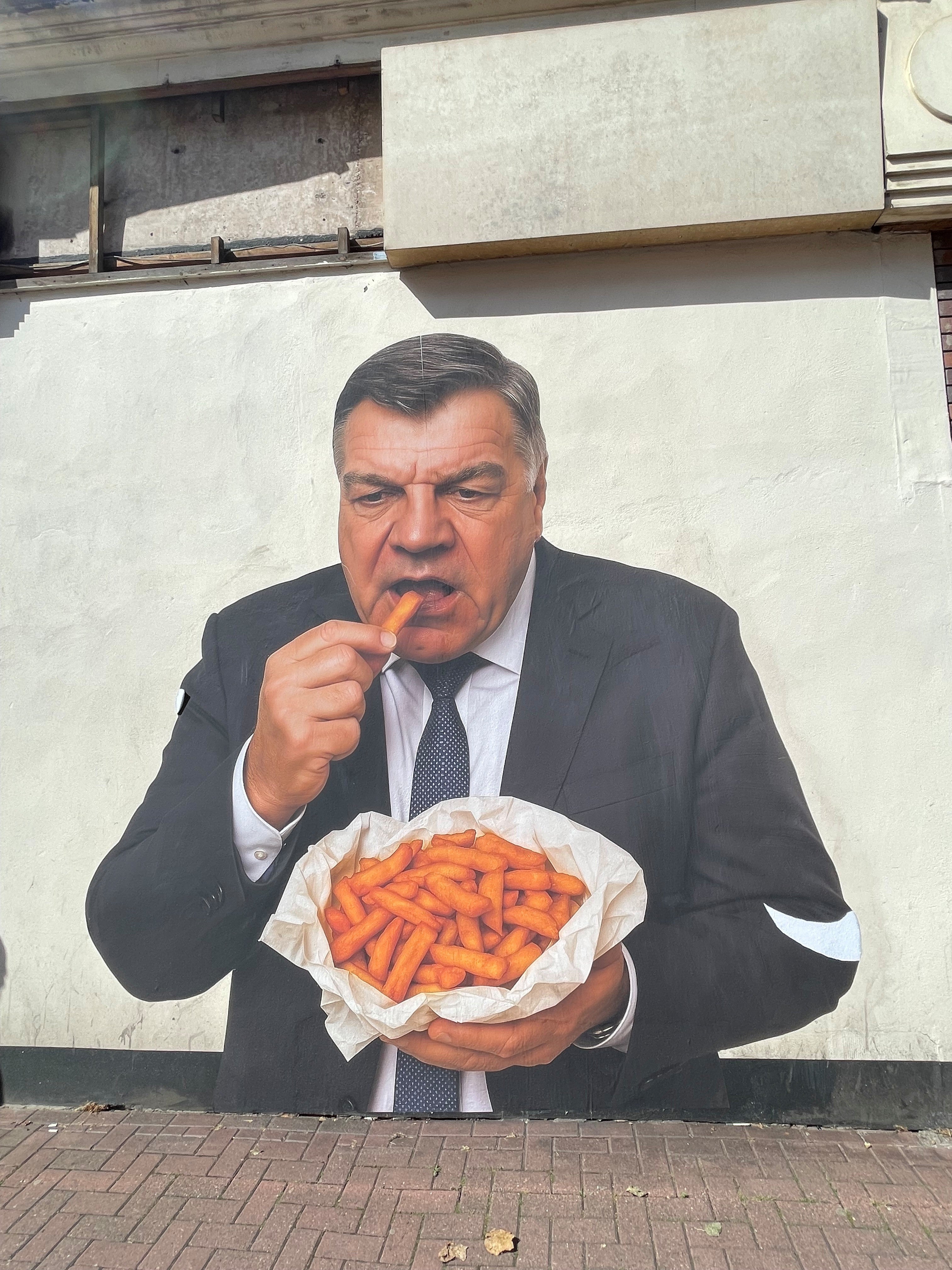 Mystery artwork of former England boss eating chips appears in town centre