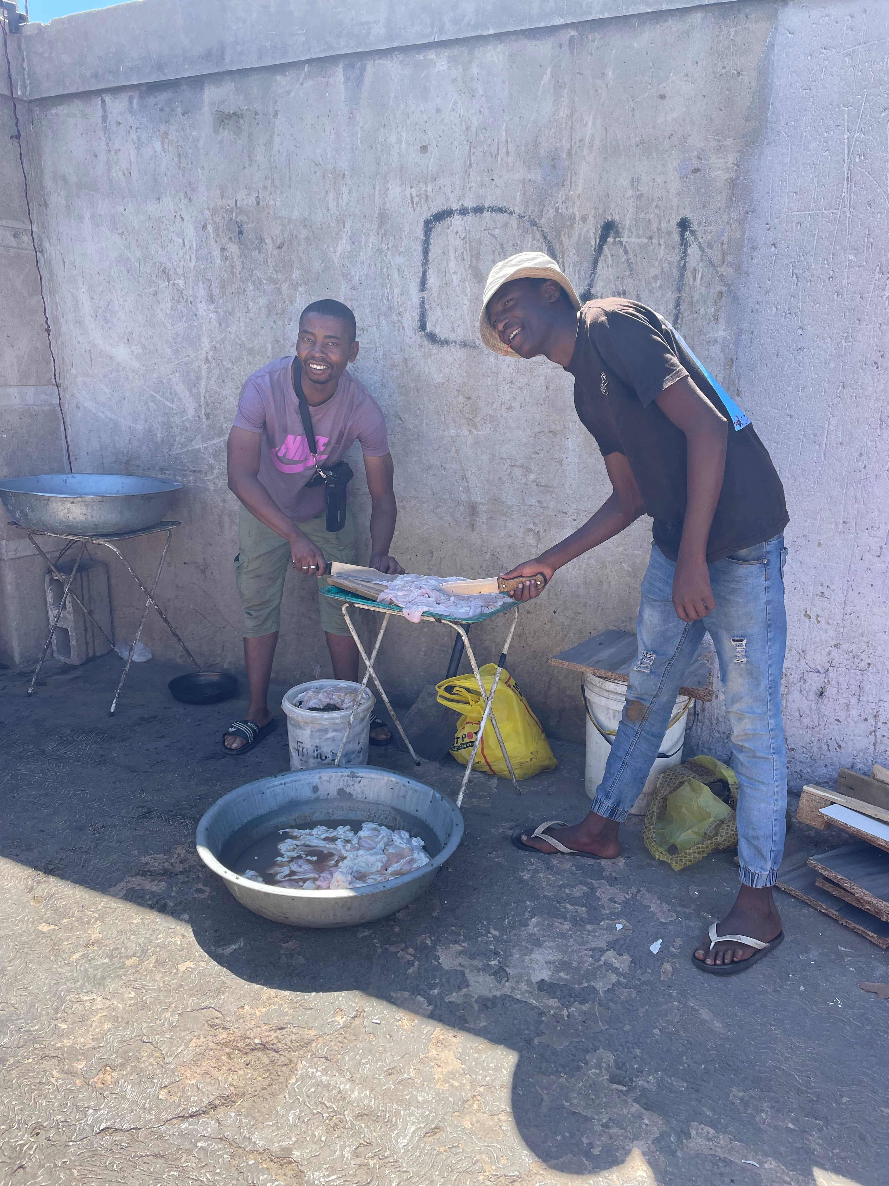 Chefs prepare chicken at one of the local restaurants