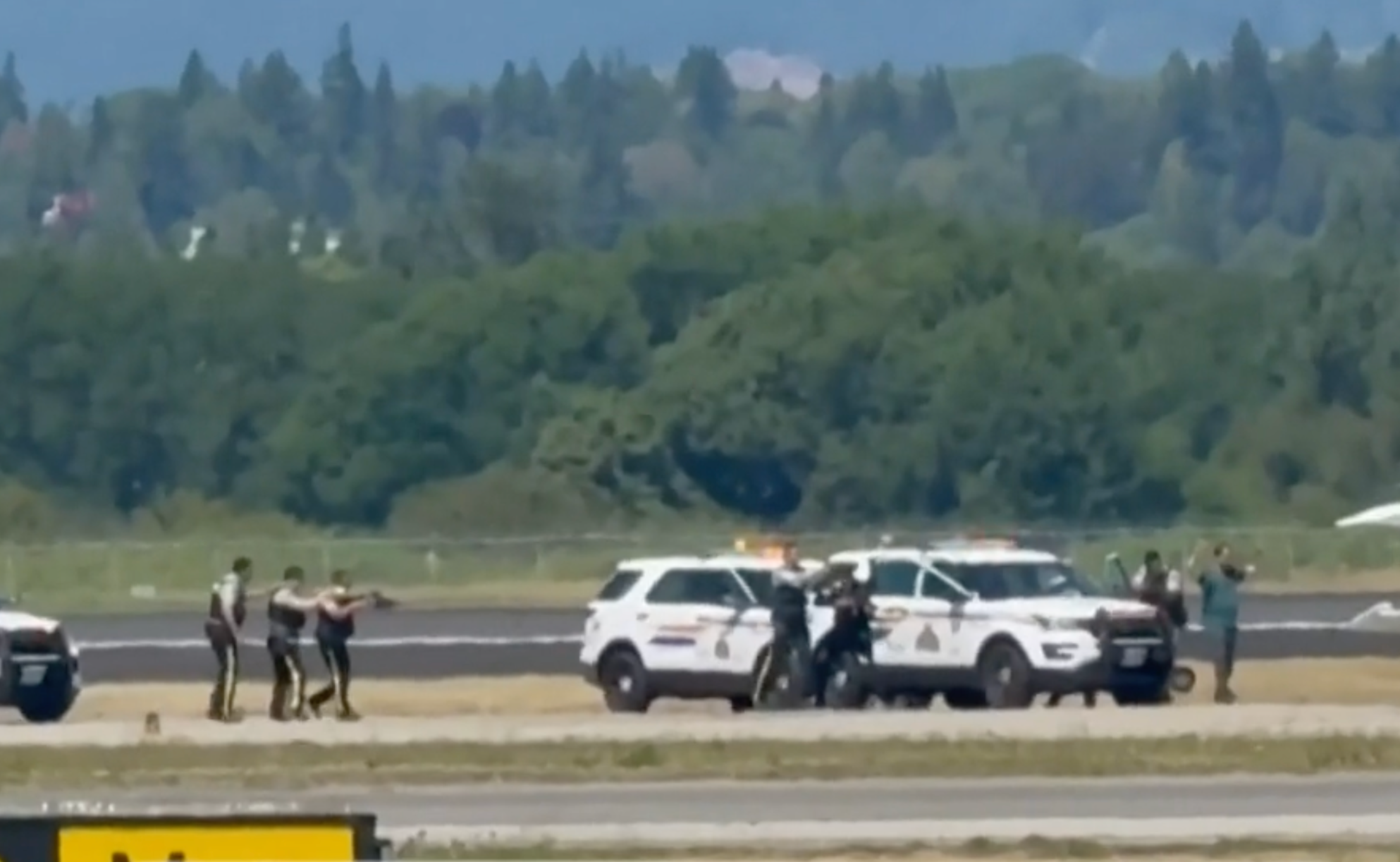 Canadian police prepare to arrest Shaheer Cassim as he walks toward them with his hands up. Cassim has been charged with hijacking, constituting terrorism