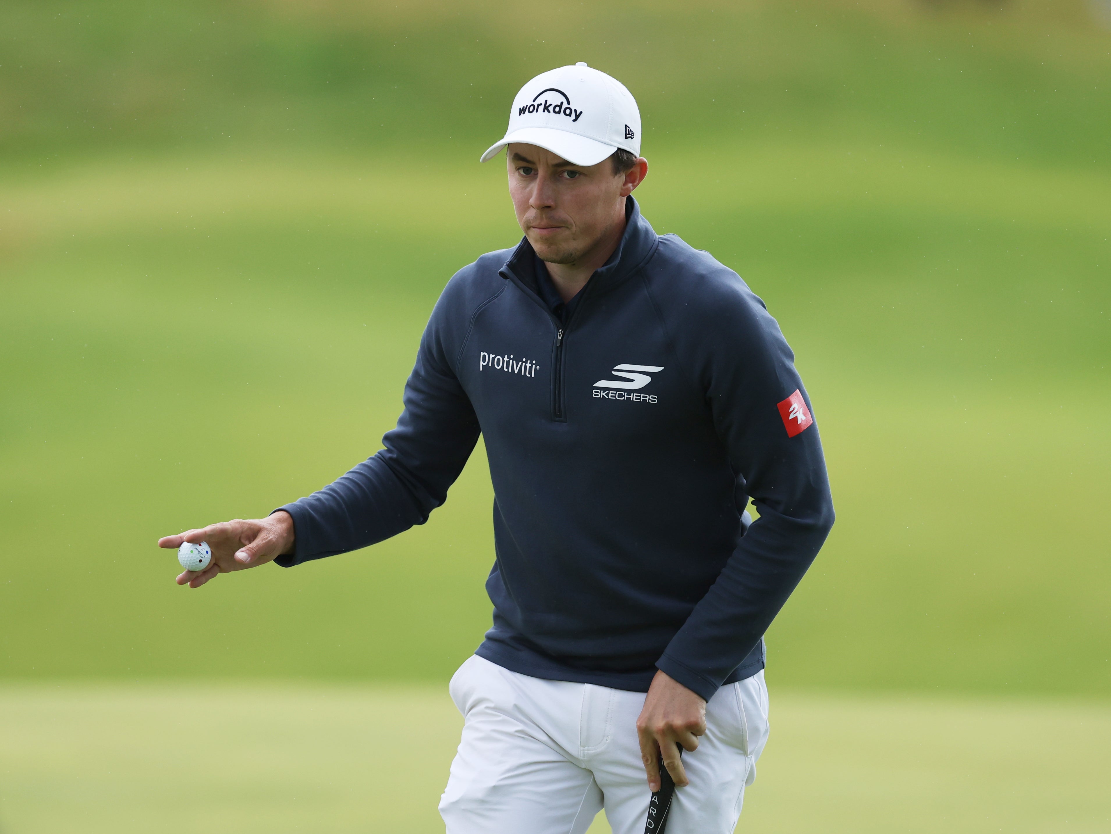 Matt Fitzpatrick of England acknowledges the crowd on the 12th green