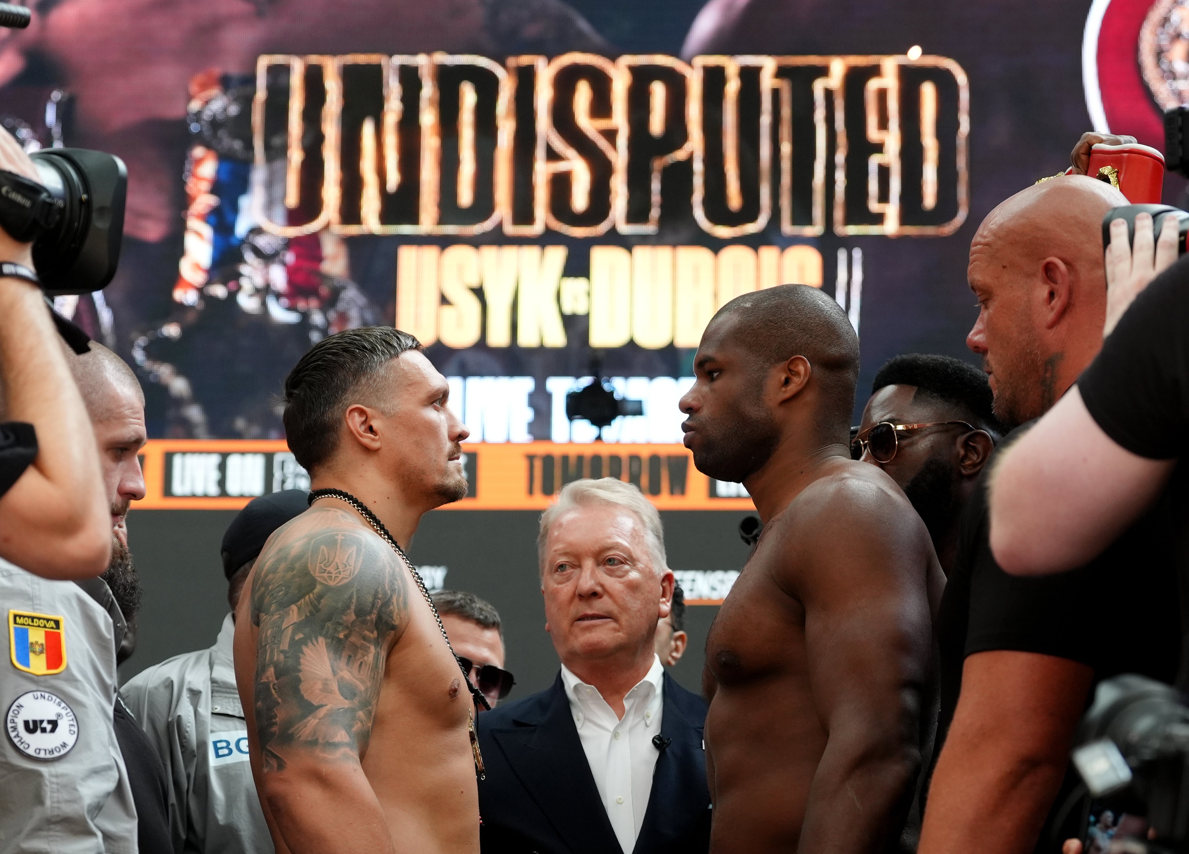 Oleksandr Usyk (left) and Daniel Dubois face off during their weigh-in (Bradley Collyer/PA).
