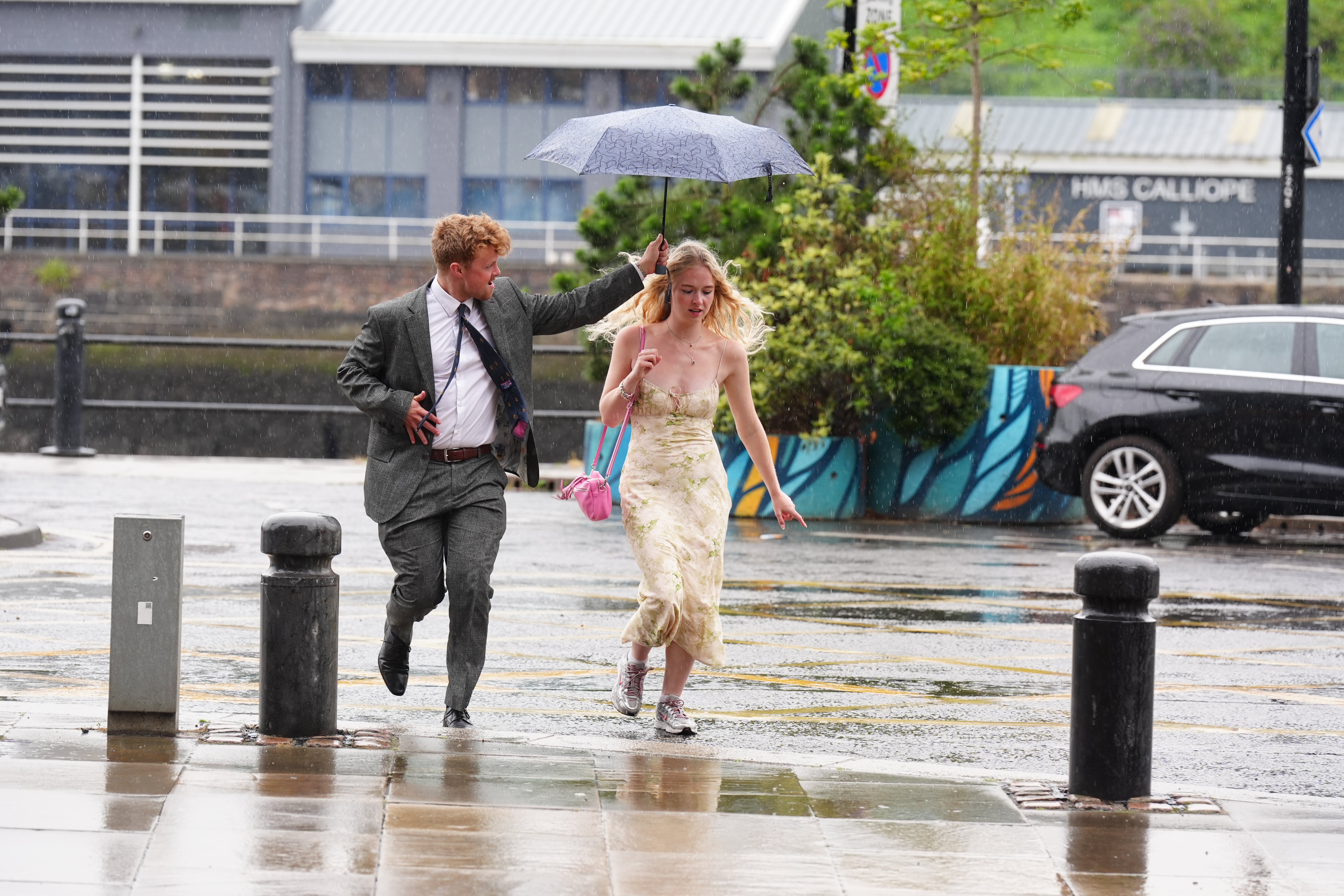 People walking in the rain at Newcastle Quayside