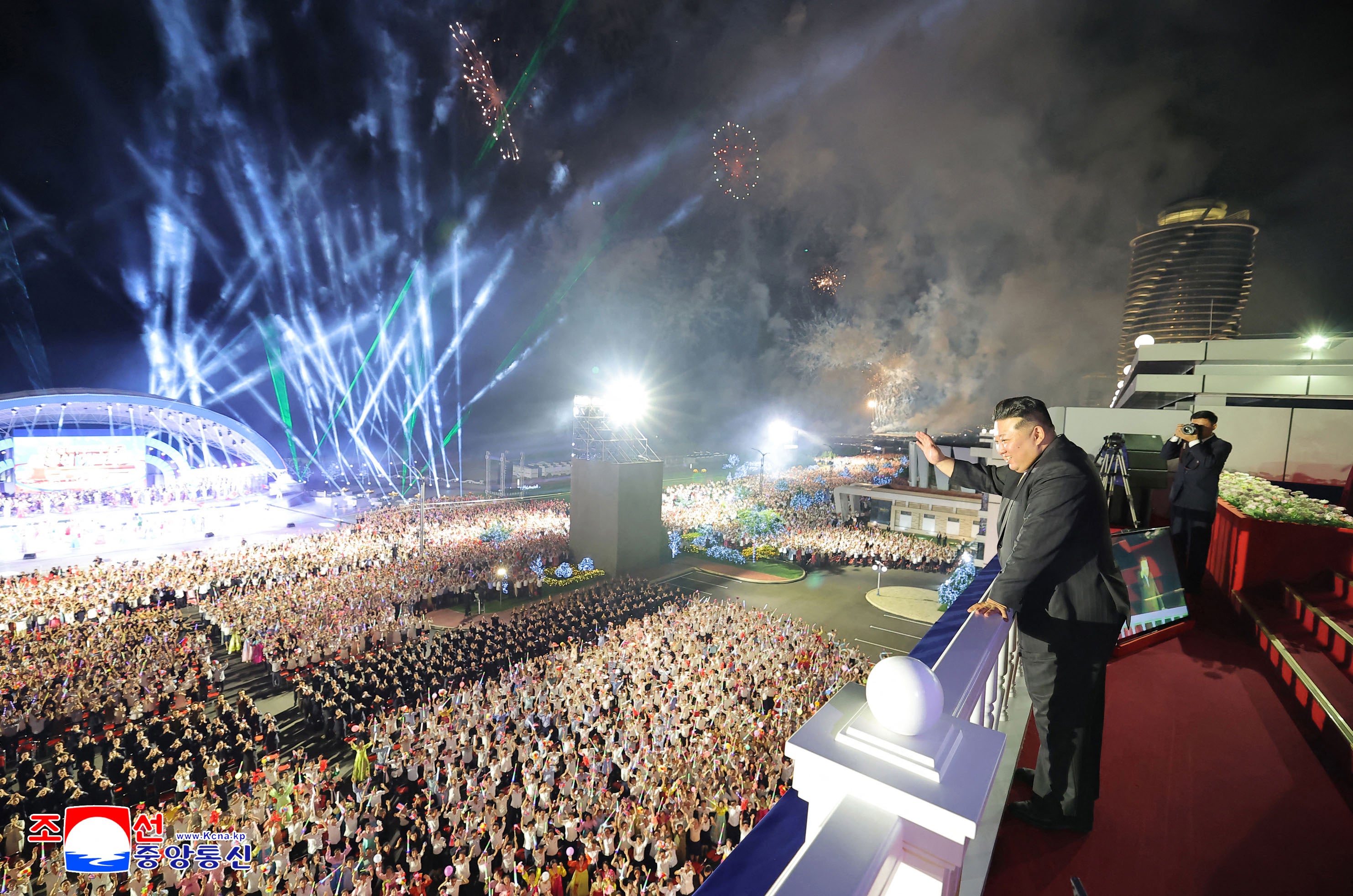 Kim Jong Un waves to a crowd at an opening ceremony for the resort