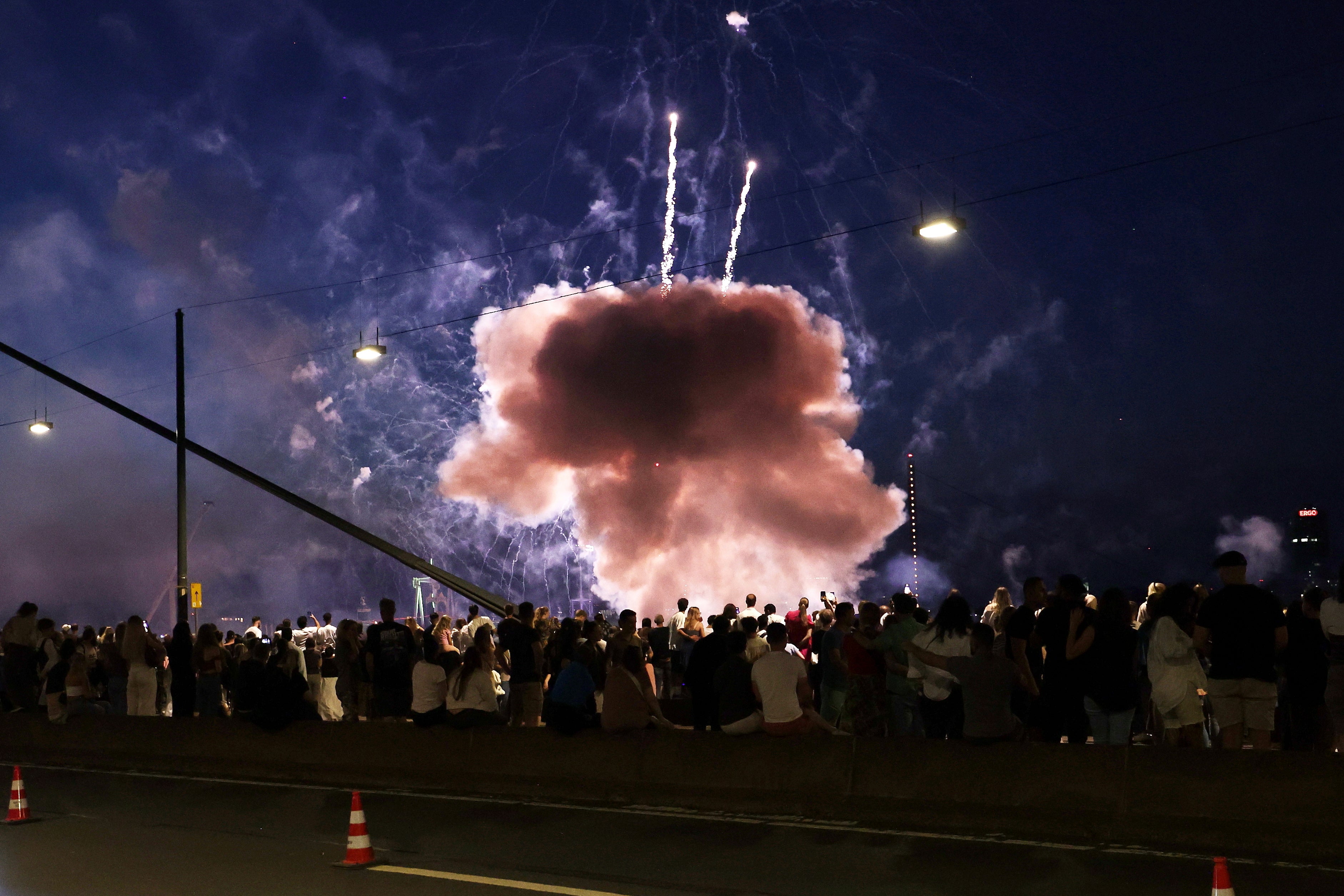 A firework explodes low near spectators at the final fireworks display of the Rhine funfair on Friday, July 18, 2025, in Duesseldorf, Germany