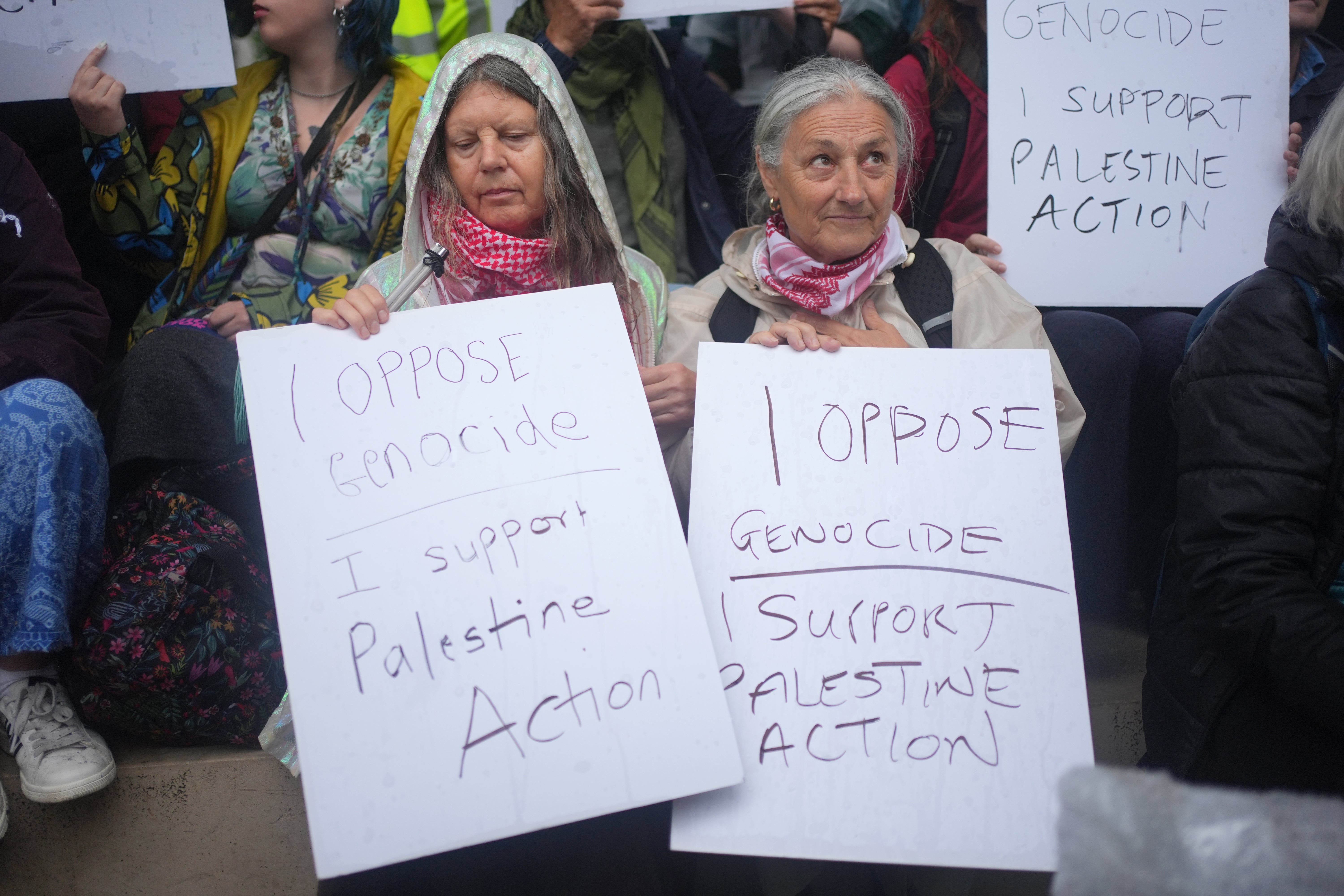 Protesters holding the signs that led to their arrest