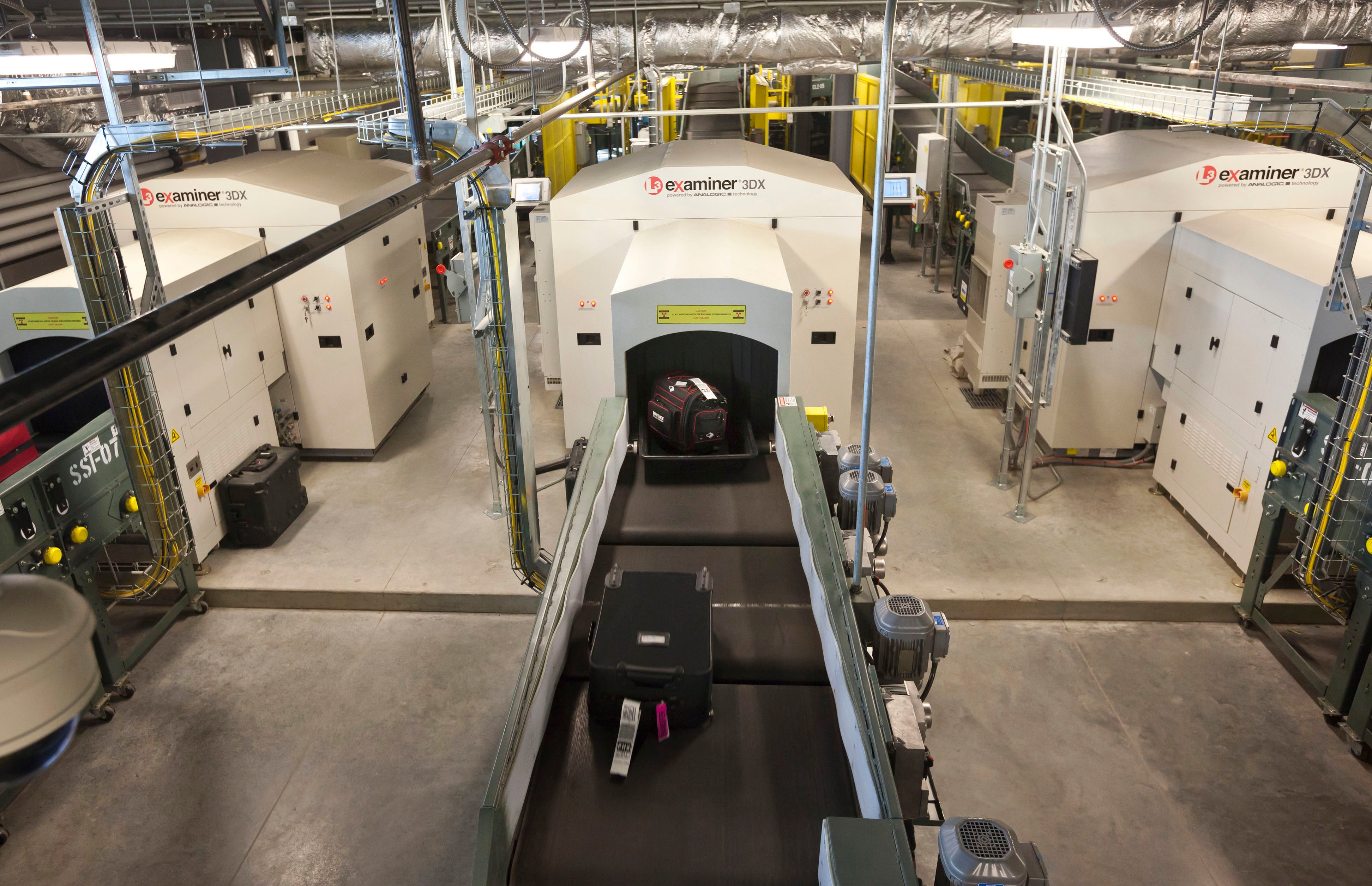 Air travelers' bags ride a conveyor into one of three new advanced in-line screening machines at Bill and Hillary Clinton National Airport in Little Rock