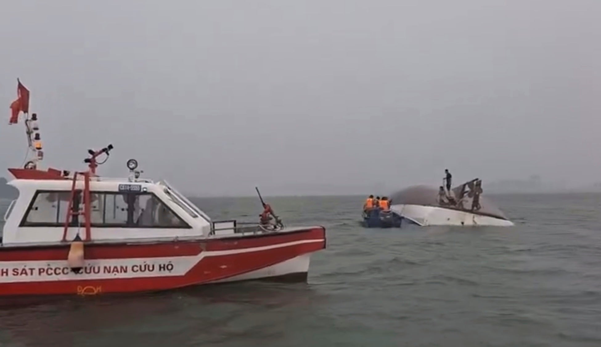 People are rescued from the capsized boat