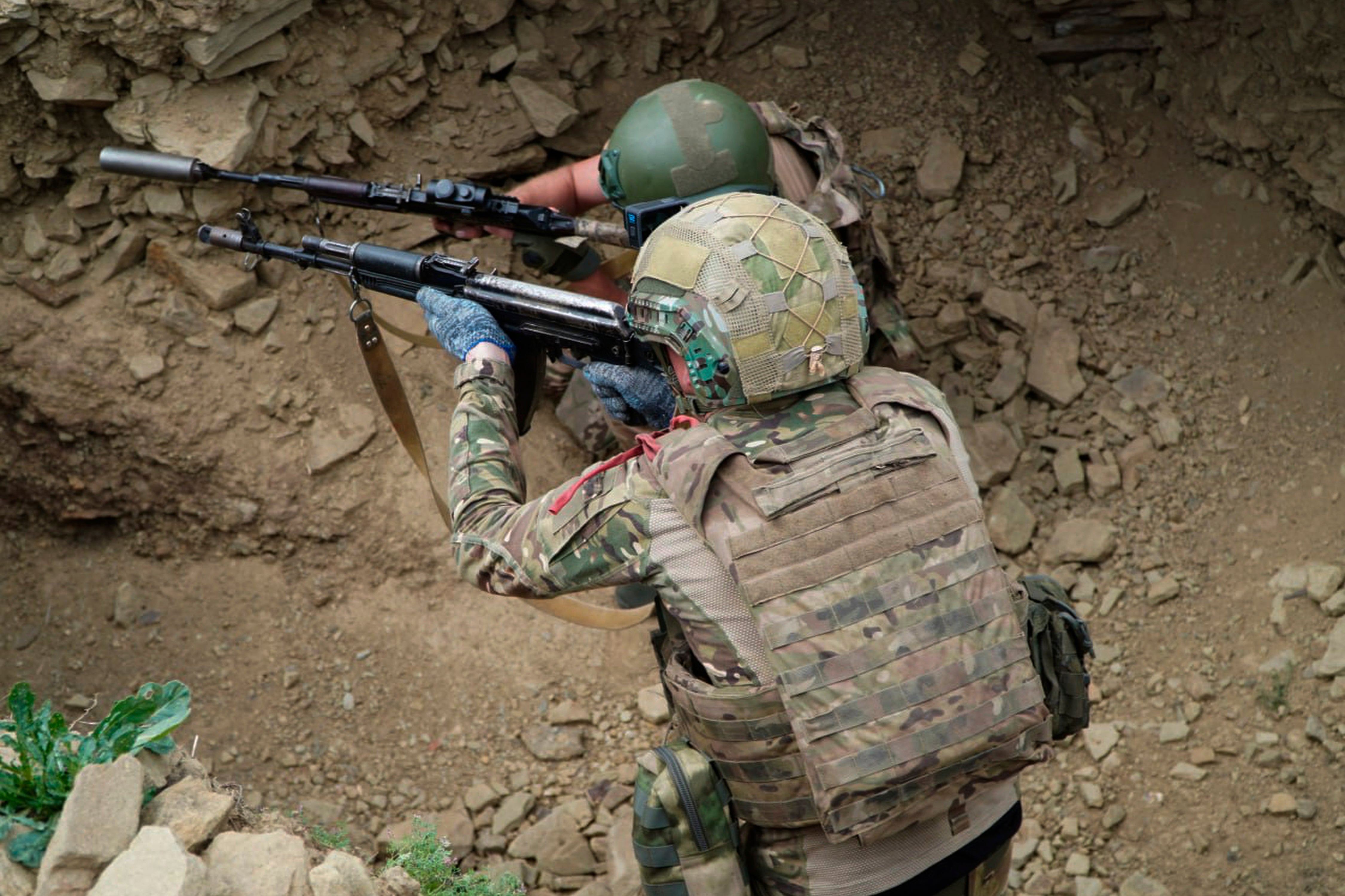 In this photo distributed by Russian Defense Ministry Press Service, assault troops of the Russian Army attend a training to hone their combat skills in an undisclosed location in Ukraine