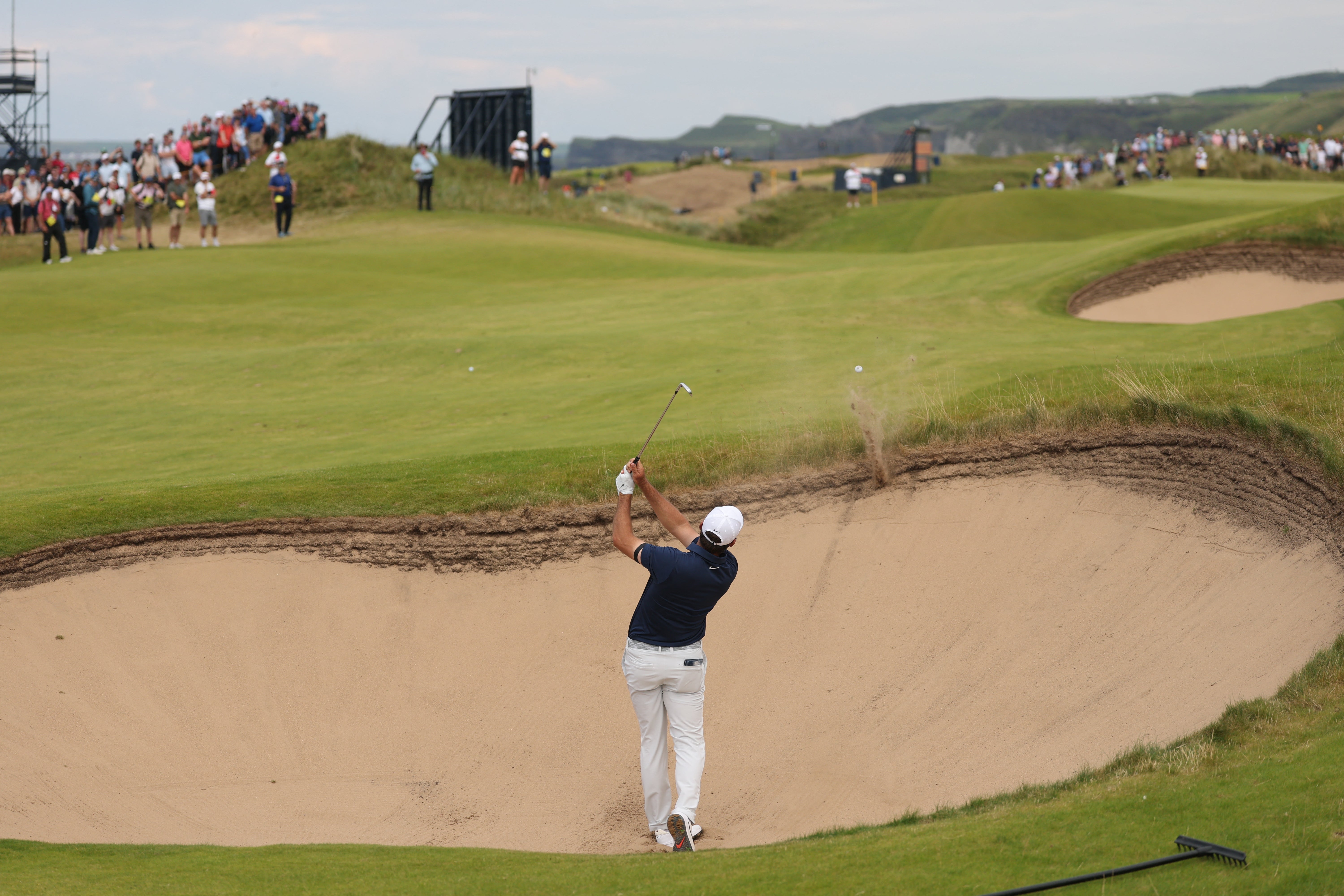 Scheffler hits from a bunker on the eighth hole