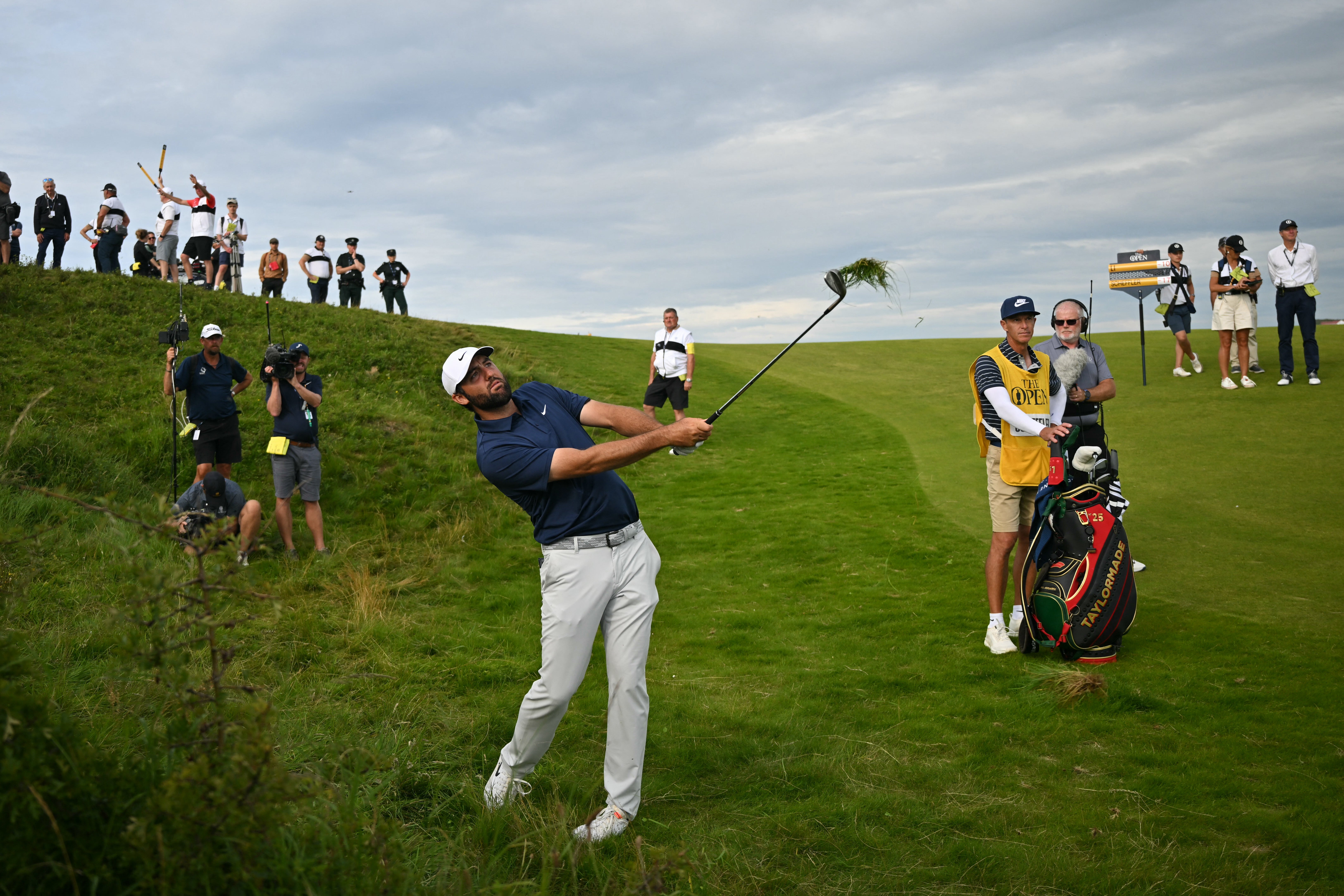 Scheffler plays from the rough on the 17th hole on day four