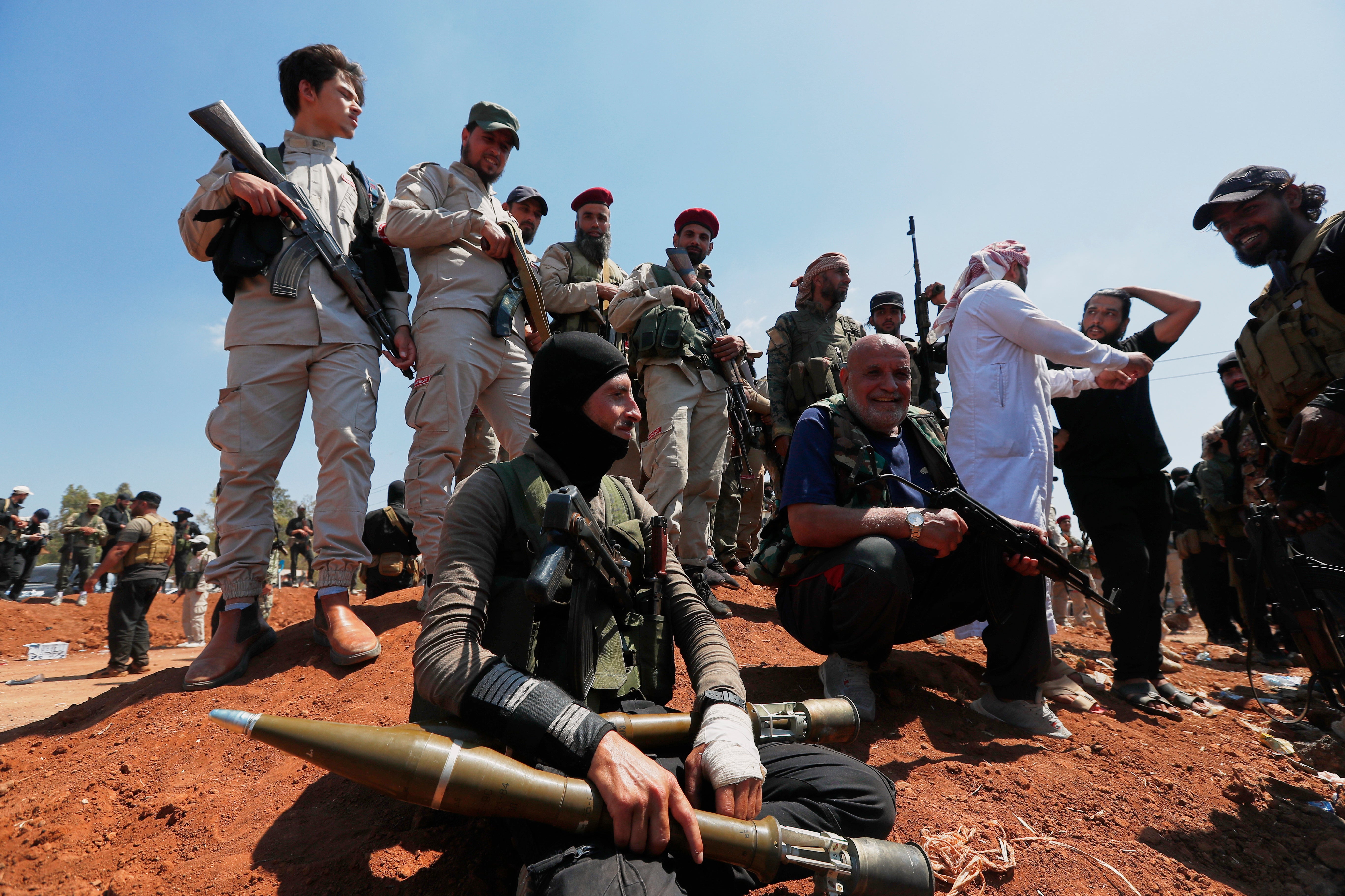 Bedouin fighters gather as Syrian government security forces block them from entering Suweida province, in Busra al-Harir village