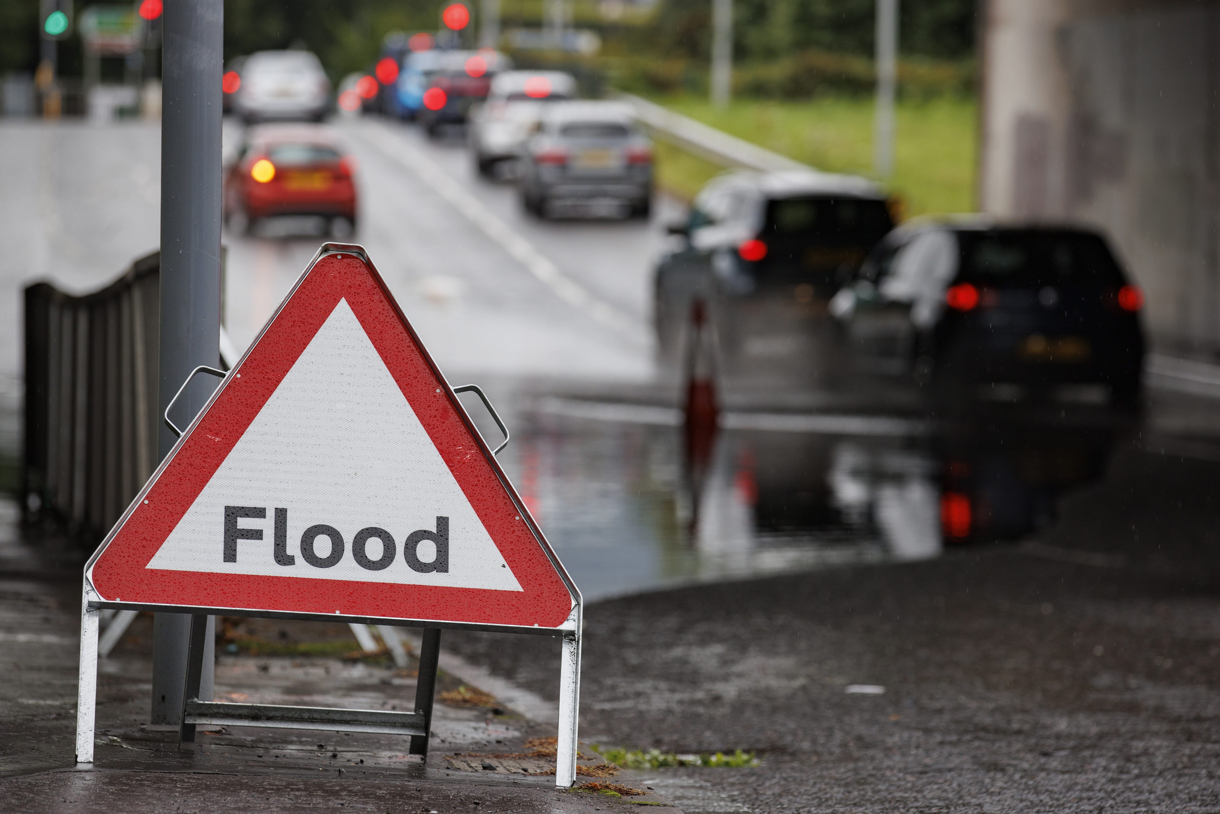 Vehicles navigate flooded rainwater in an underpass on Blacks Road in Belfast (Liam McBurney/PA)