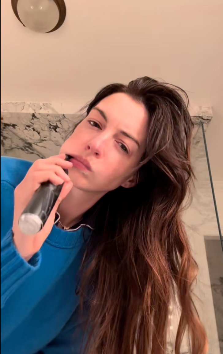 Anne Hathaway wears a cerulean blue sweater as she announces Devil Wears Prada sequel has begun filming