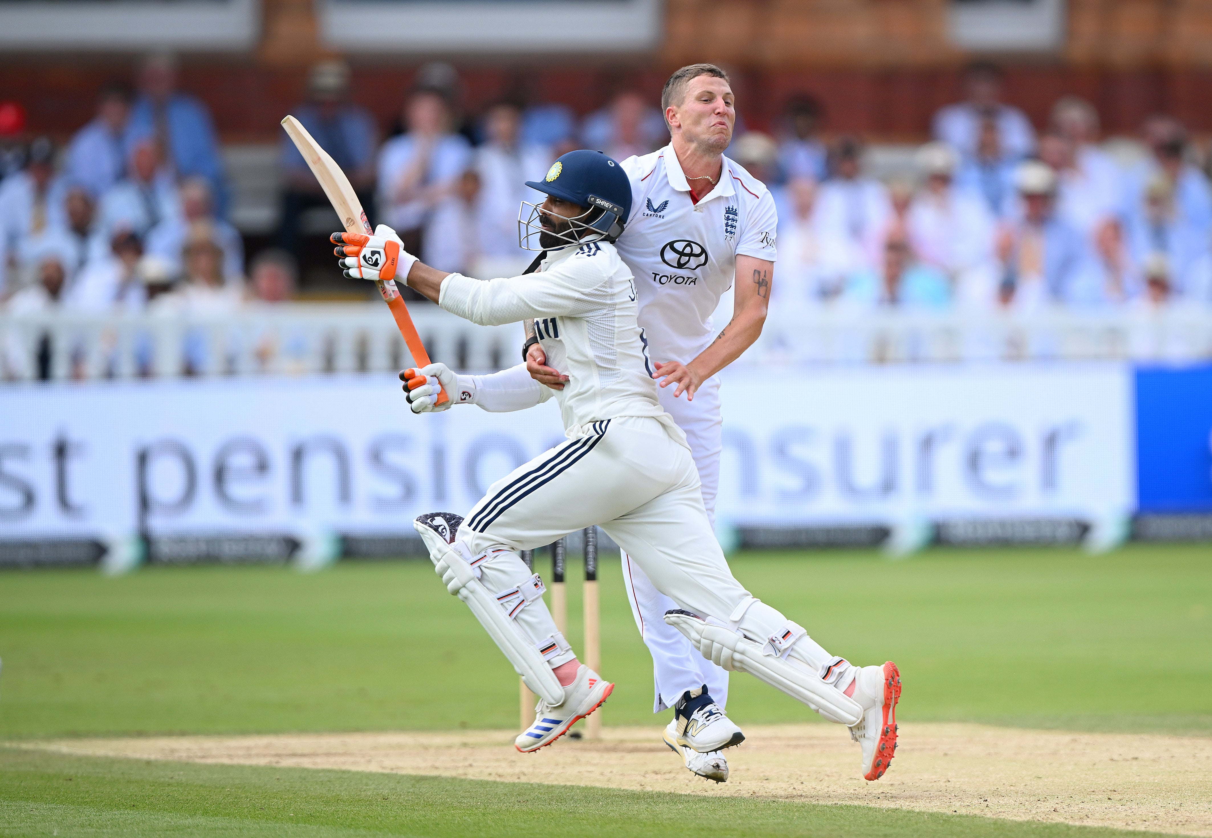 Brydon Carse (right) colliding with Ravindra Jadeja