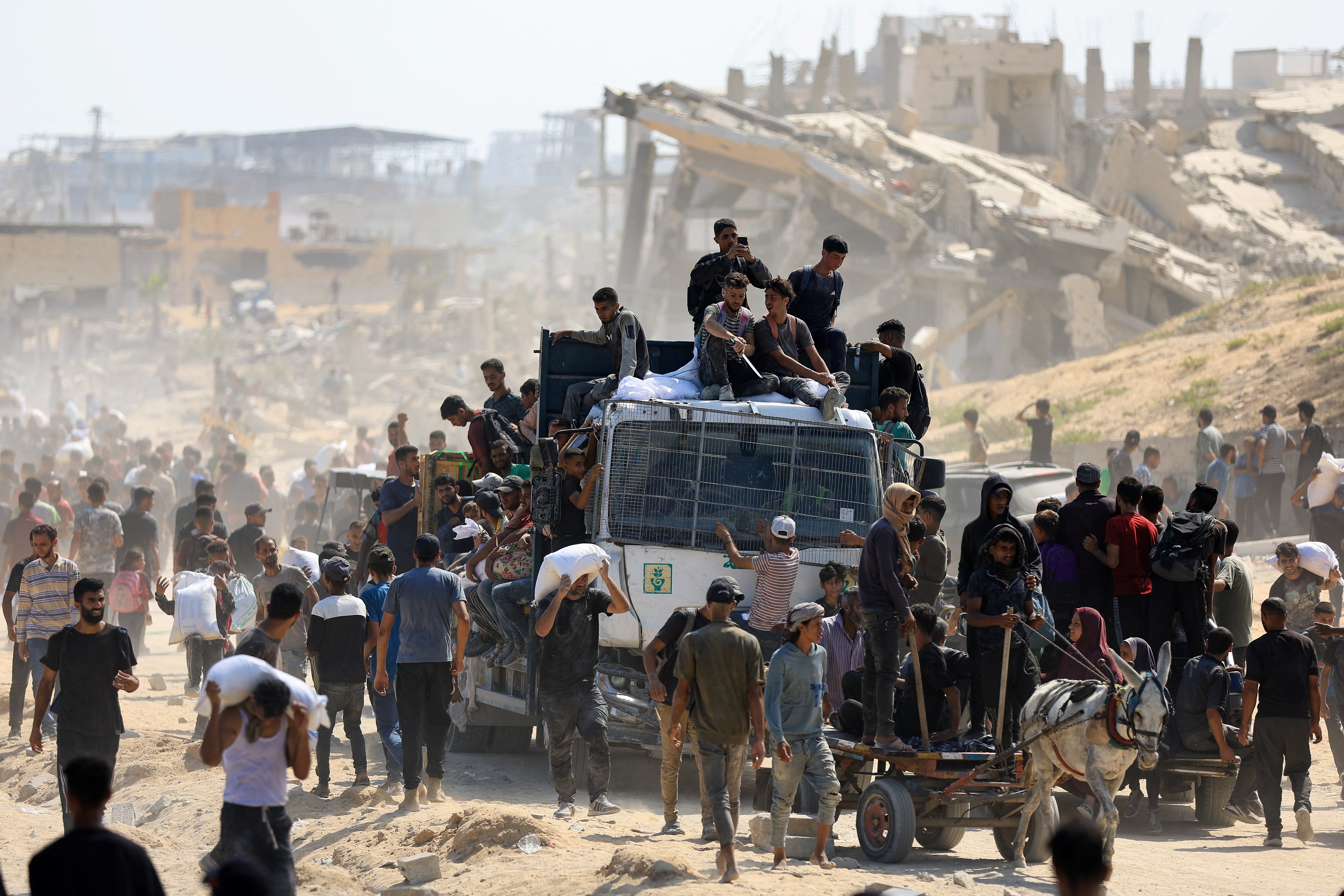 Palestinians gather as they seek aid supplies that entered Gaza through Israel in Beit Laha