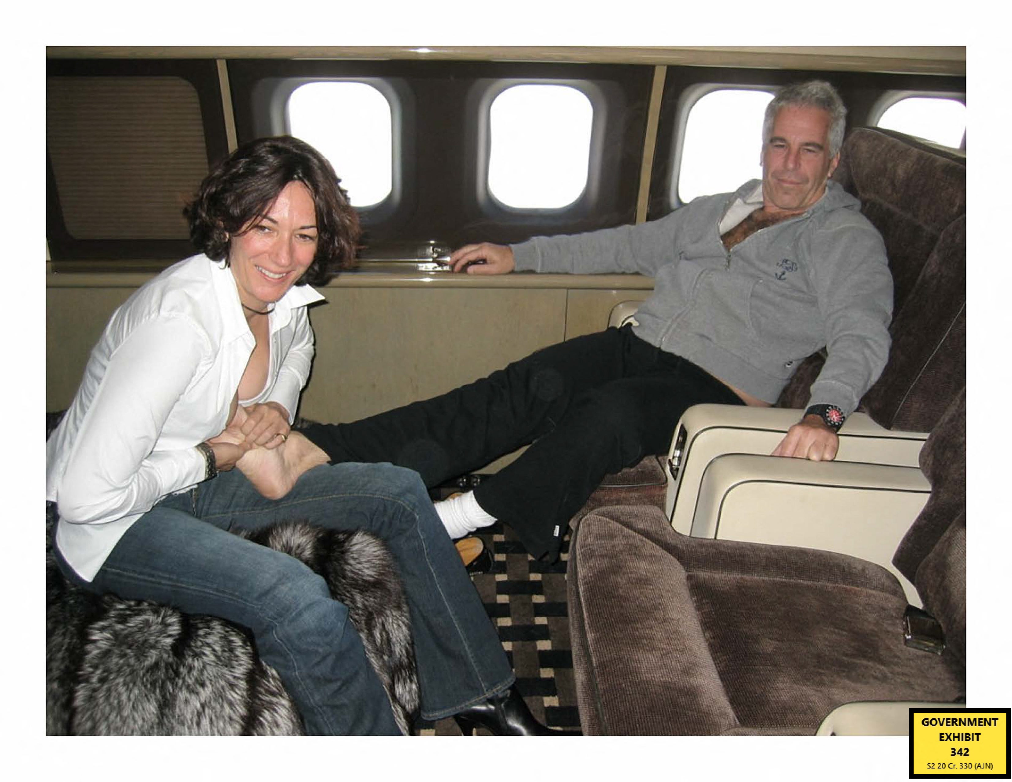 Trial evidence image shows British socialite Ghislaine Maxwell and financier Jeffrey Epstein aboard his private jet. Epstein was found to have died by suicide in a New York prison in 2019 -- during Trump's first term -- after being charged with child sex trafficking. Maxwell was later convicted of those crimes and is serving 20 years in prison.
