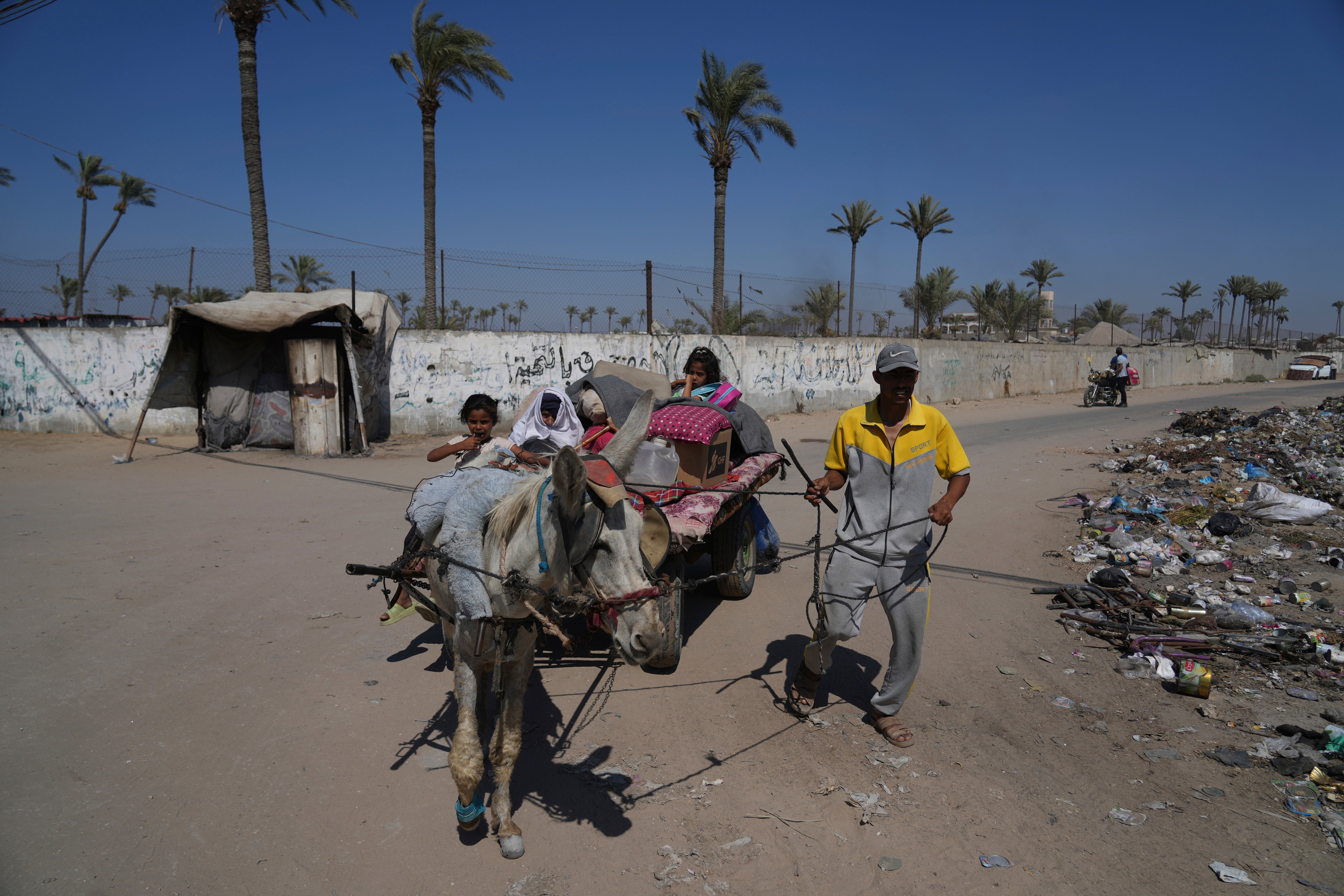 Palestinians flee Deir al-Balah in central Gaza on Sunday, July 20, 2025, after the Israeli military issued evacuation orders ahead of expected operations in the area