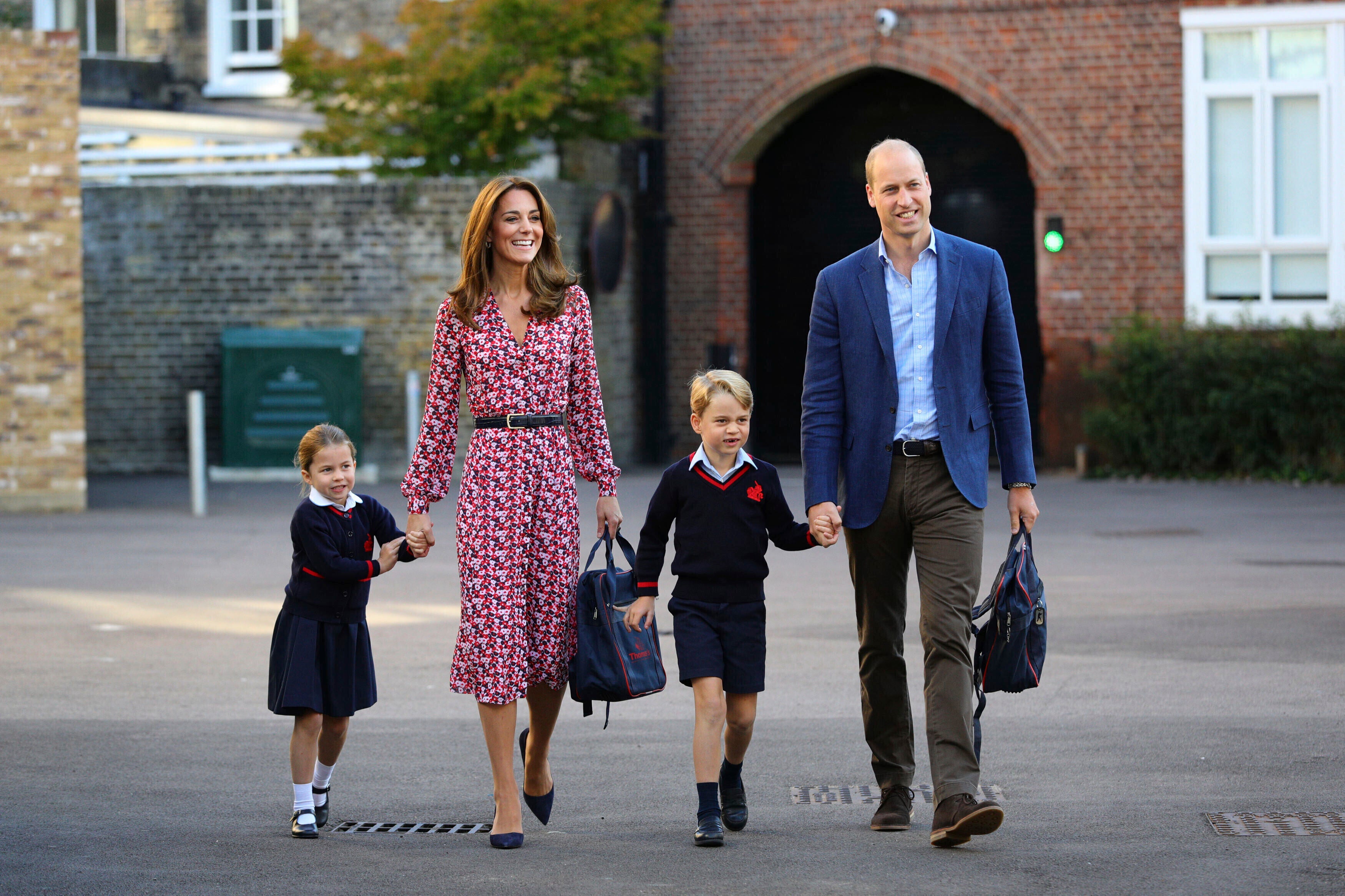 Princess Charlotte, left, with her brother Prince George and their parents Prince William and Kate, Duchess of Cambridge, arrive for her first day of school at Thomas's Battersea in London, Sept. 5, 2019