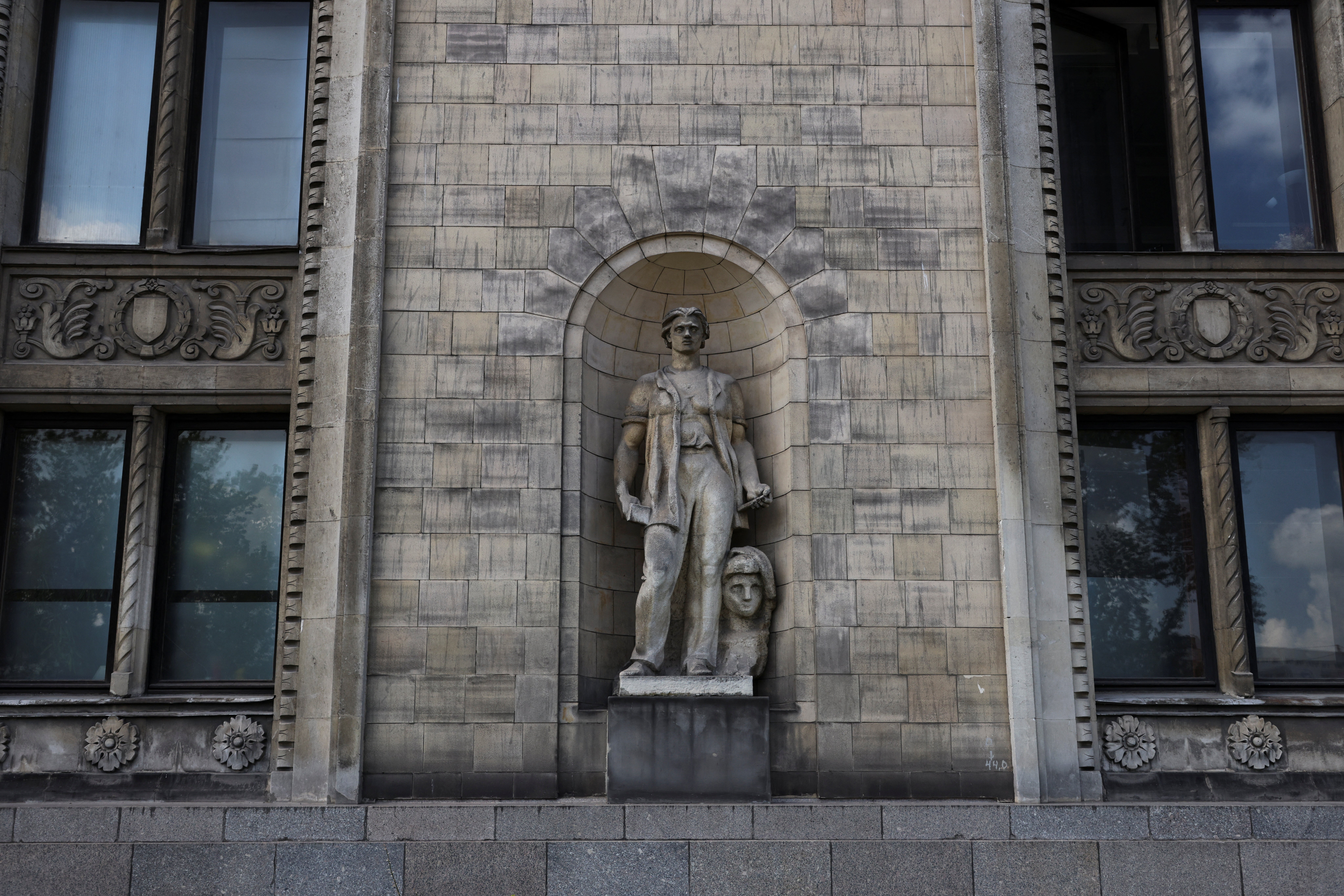 A socialist realist sculpture is seen on the facade of the Palace of Culture and Science in Warsaw