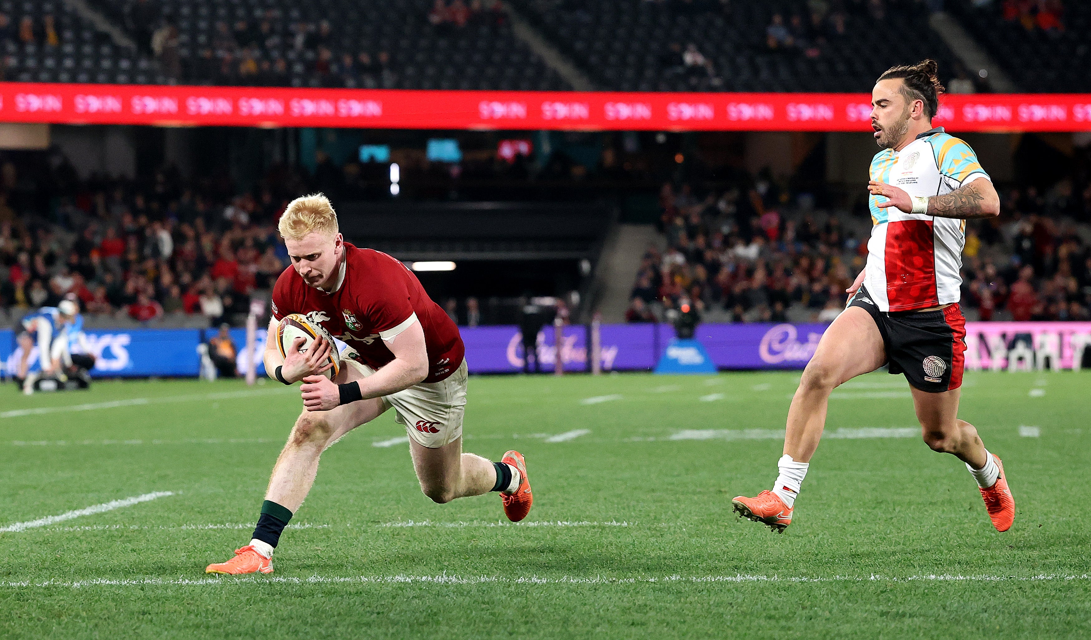 The Lions’ Jamie Osborne dives over for the third try