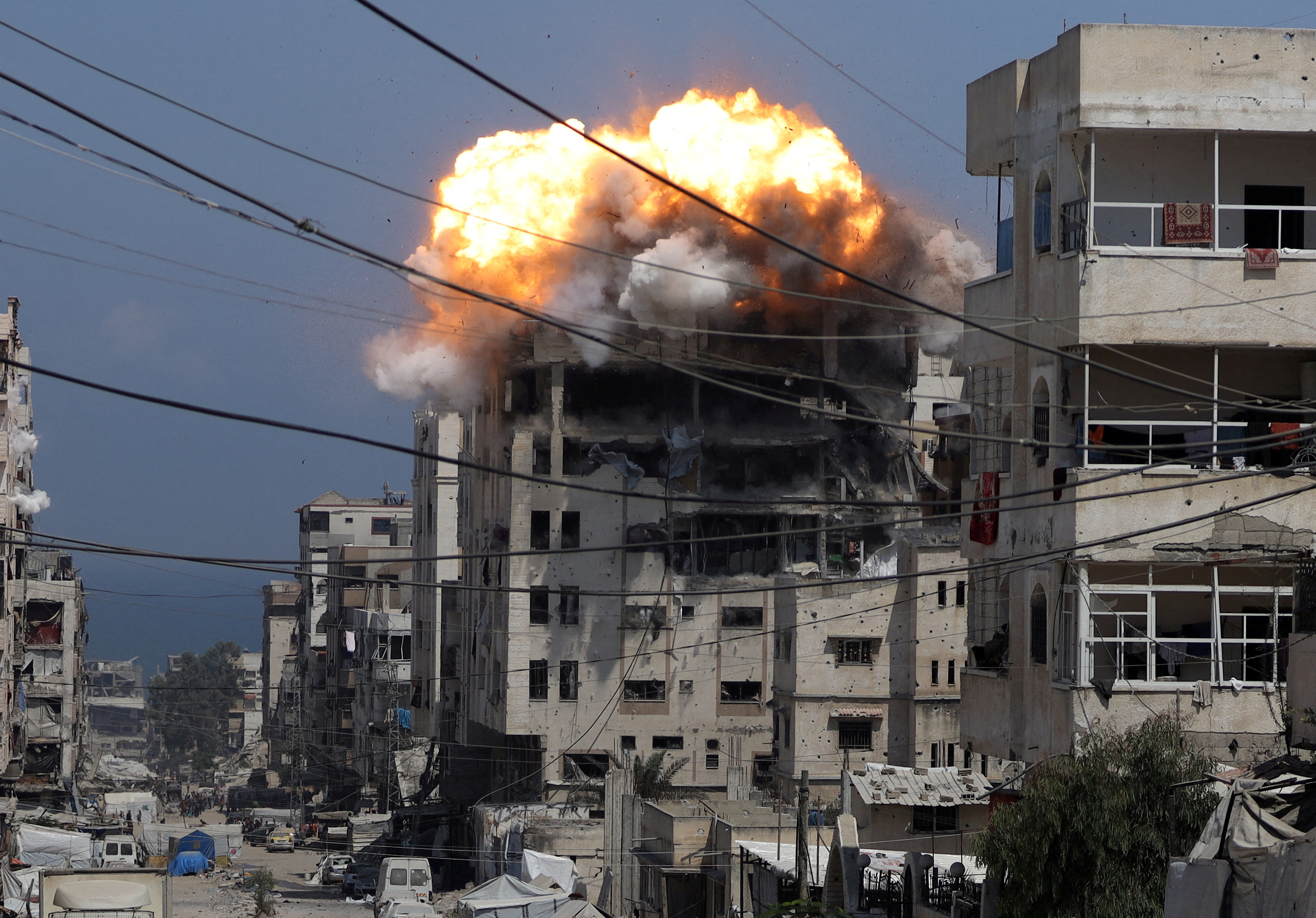 Smoke and flames rise from a residential building hit by an Israeli strike in Gaza on 21 July 2025
