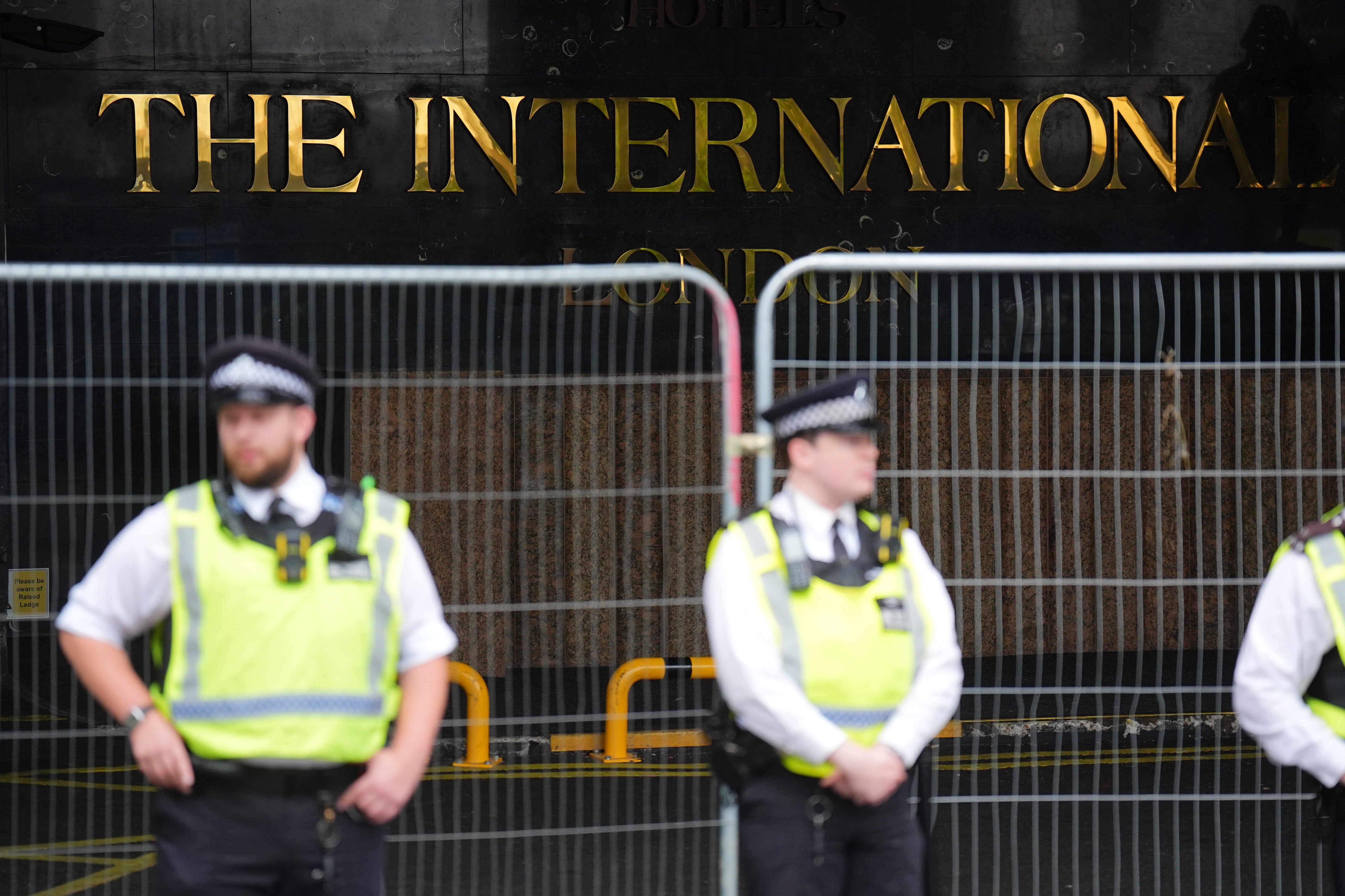 A 22-year-old woman has been charged with assaulting a security guard at a hotel housing migrants after one of its residents allegedly walked into her flat