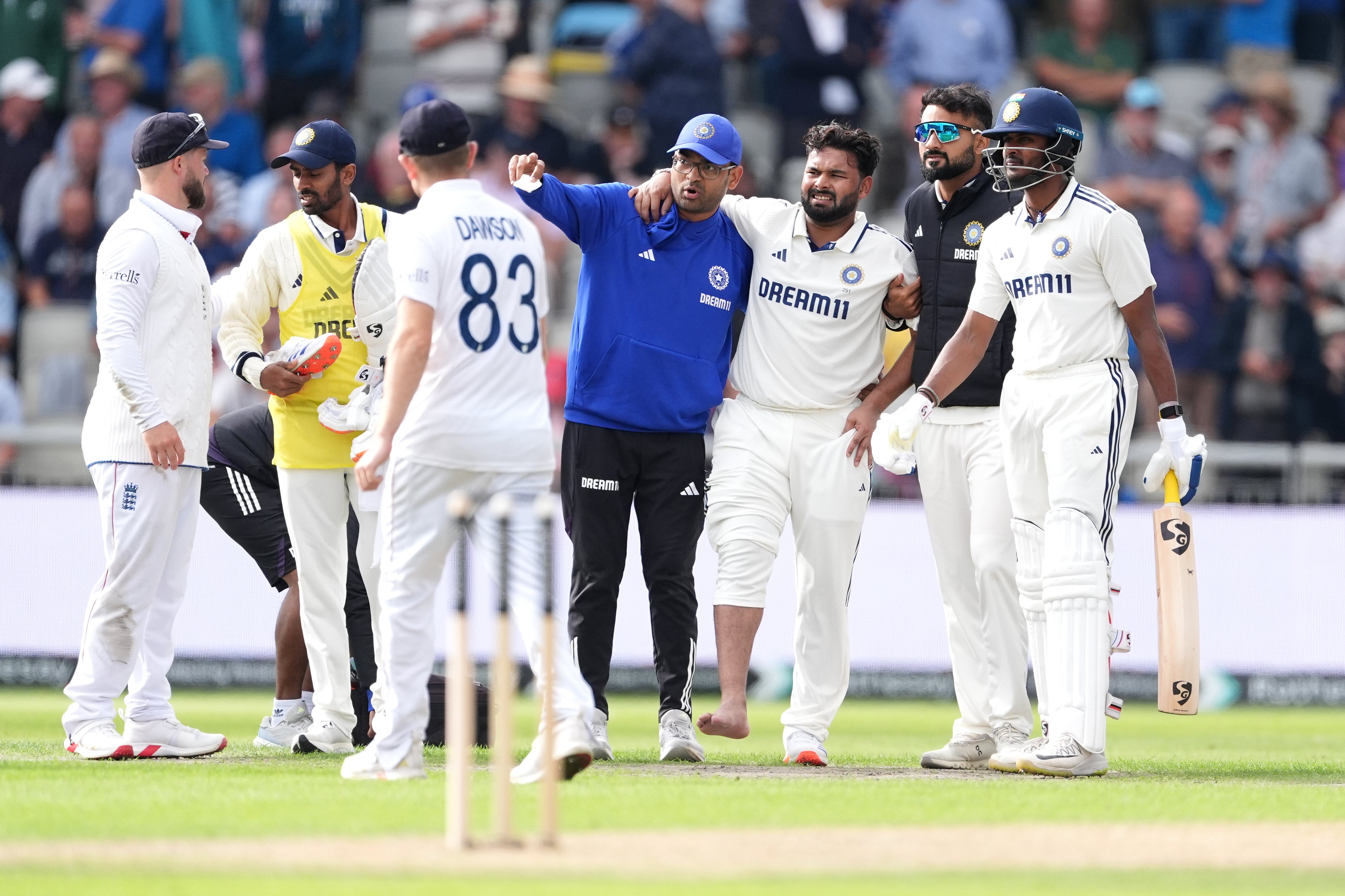 Rishabh Pant (centre right) is helped off the field (Martin Rickett/PA)