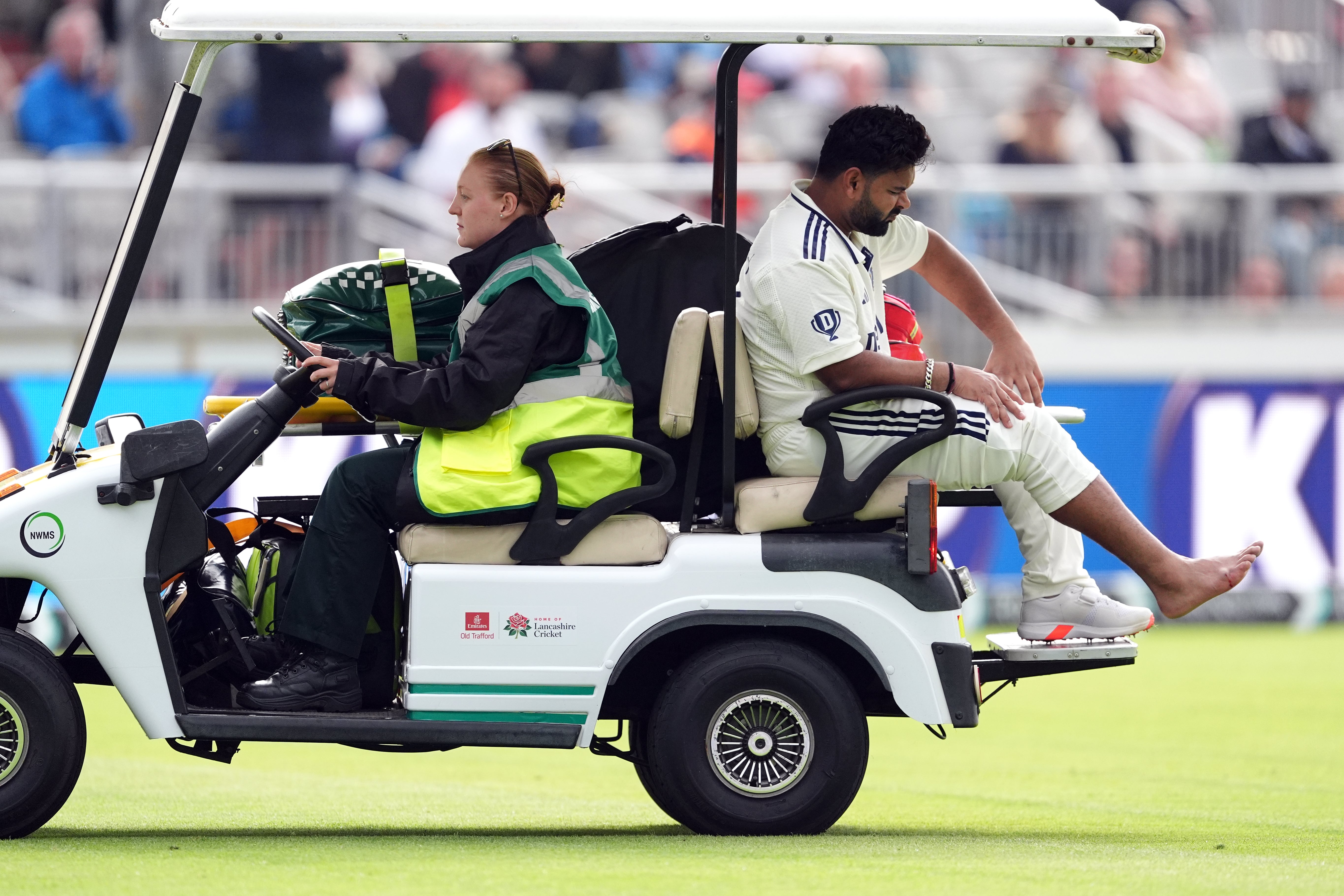 Rishabh Pant (centre right) was taken off the field in a golf buggy (Martin Rickett/PA)