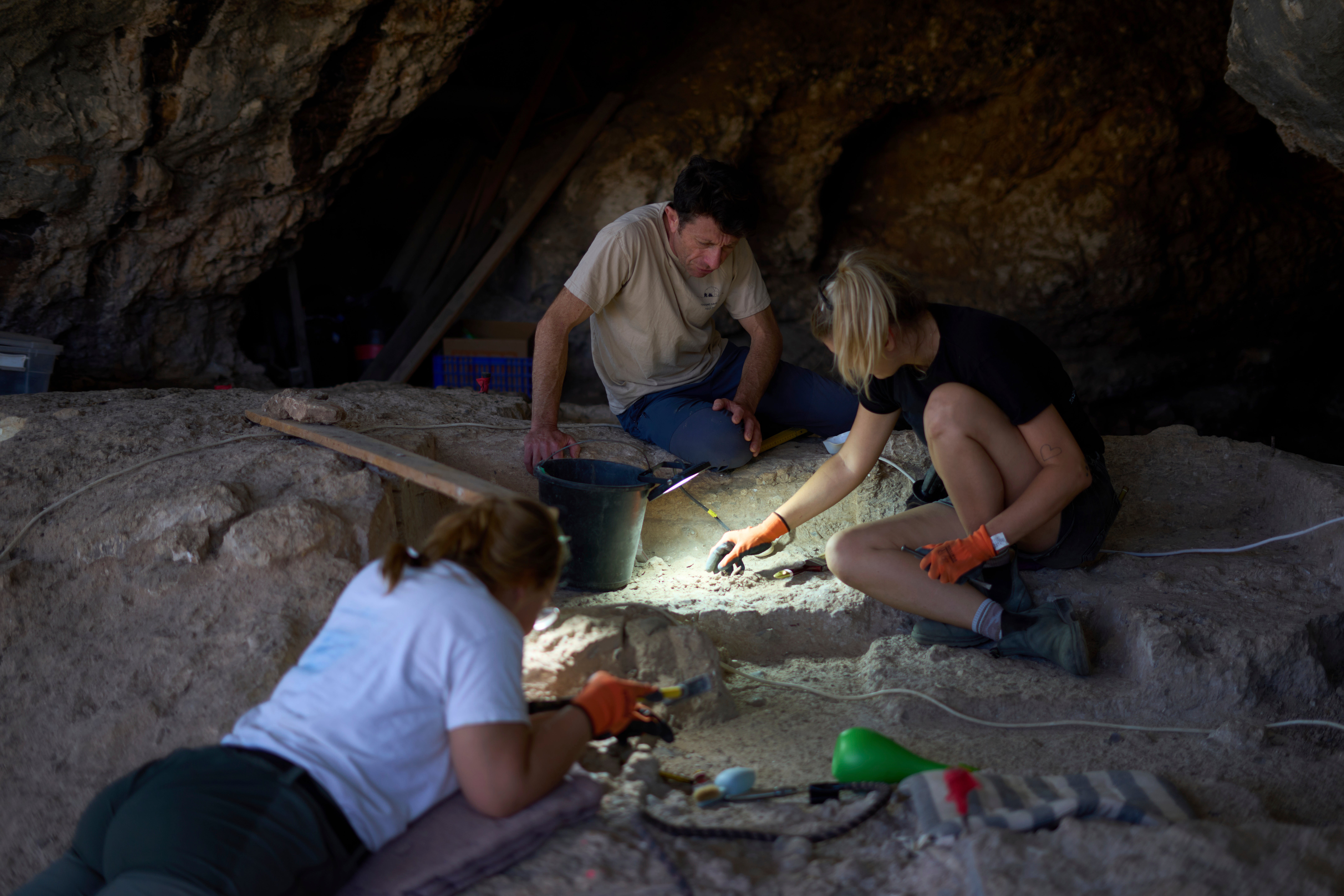 Professor of Archaeology Yossi Zaidner, centre, works in Tinshemet Cave