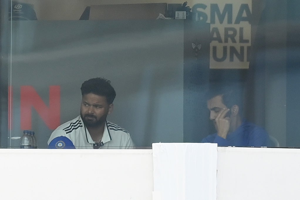 Rishabh Pant of India watches from the dressing room