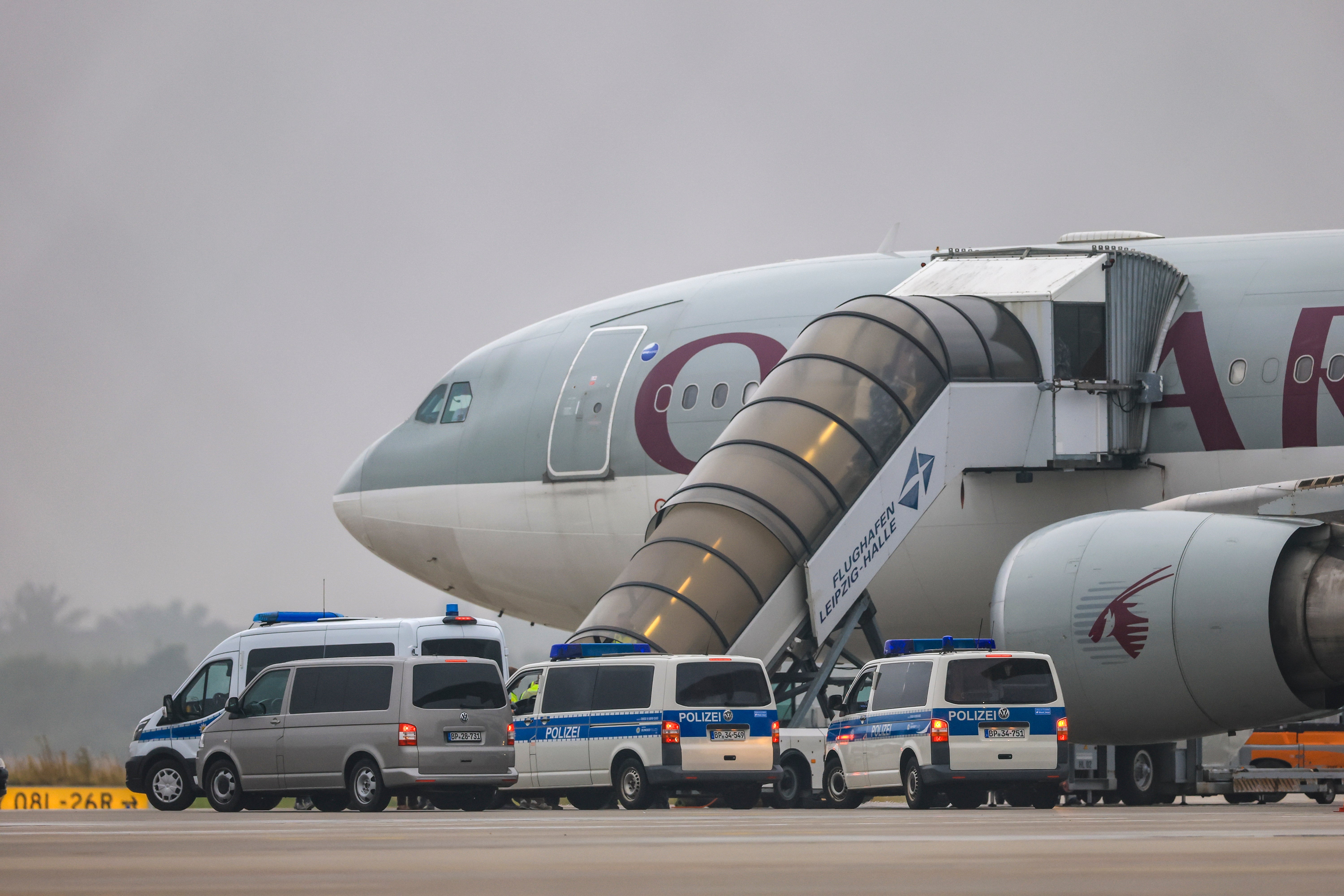 File. People board a Qatar Airways plane