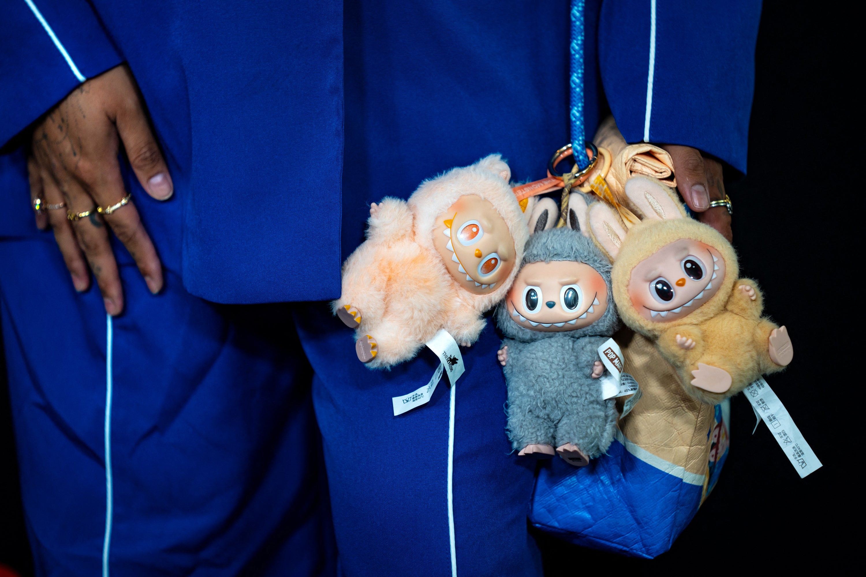 Their popularity has pushed consumers to seek out fake versions of the toys, which are commonly seen dangling from luxury bags, with some capitalising on the craze.