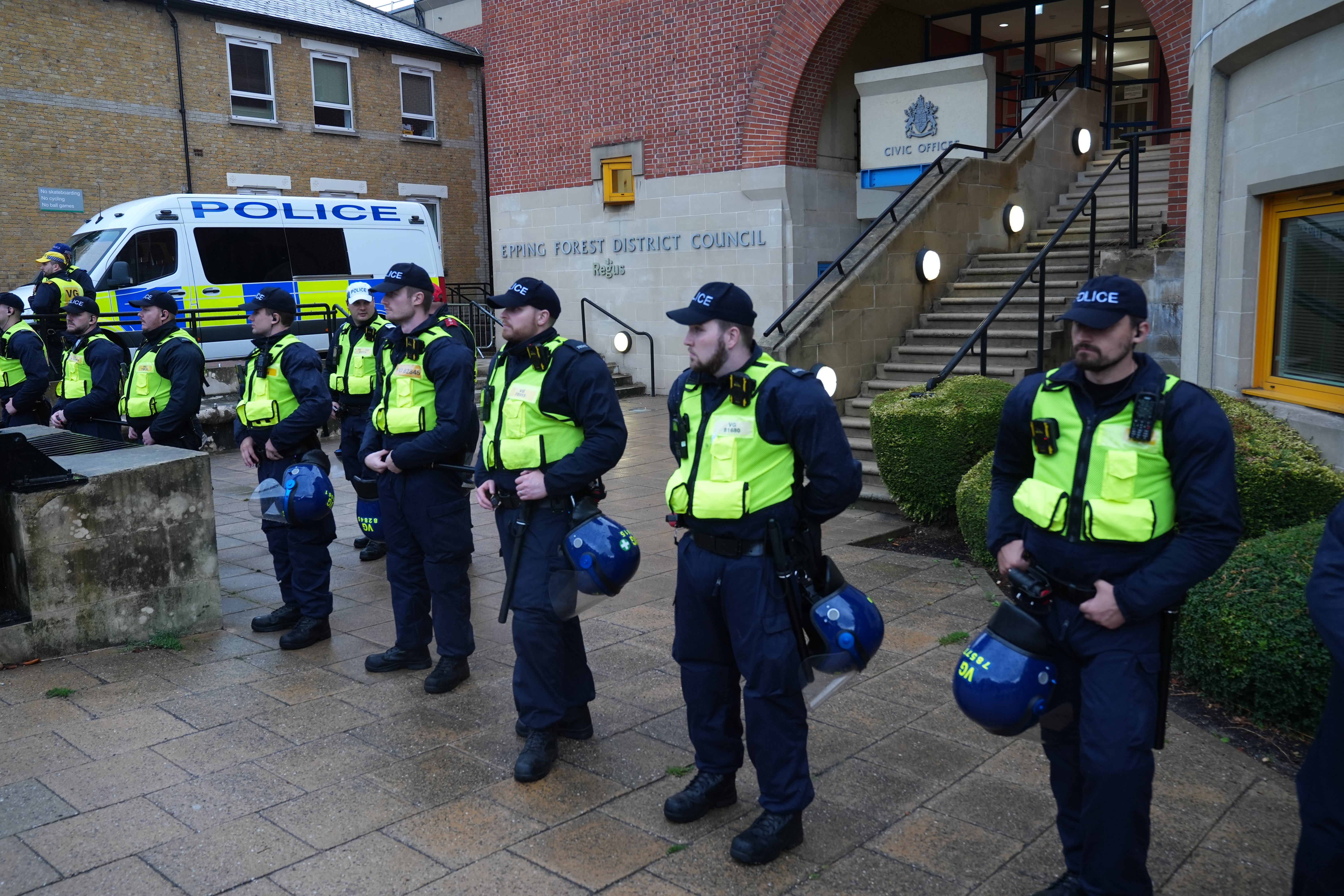 Police watch protesters outside the Bell Hotel on Thursday following a number of demonstrations there