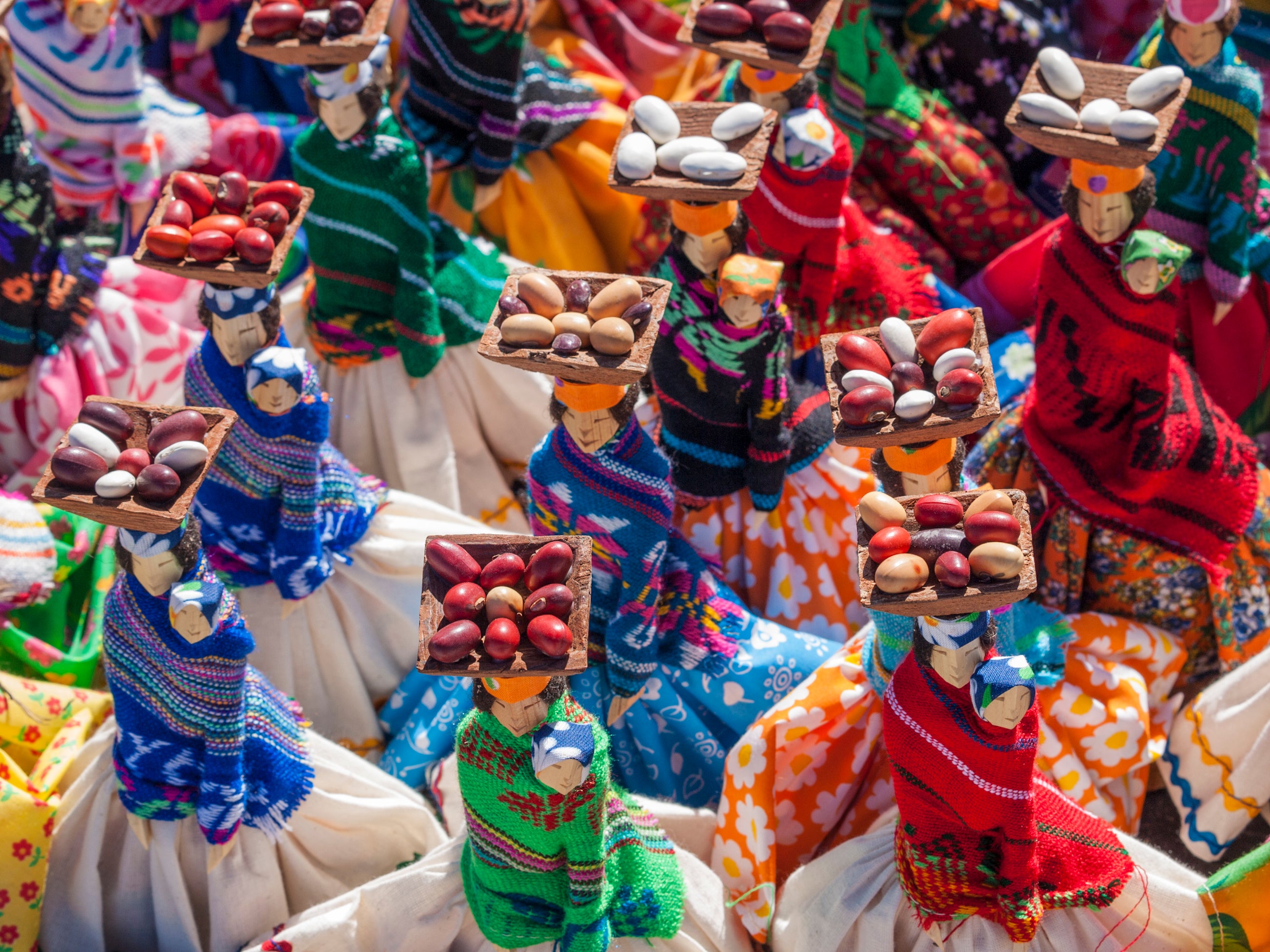 Hand-made souvenir dolls with coffee beans in the baskets on their heads are sold in the town of Creel, northern Mexico