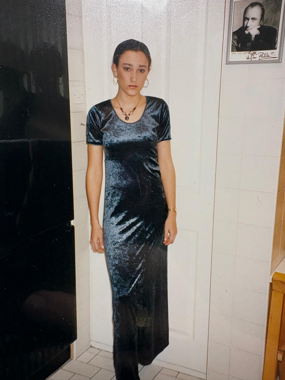 Victoria Richards in 1996 (or thereabouts), with a River Island crushed velvet dress and a prized signed photo of Phil Collins