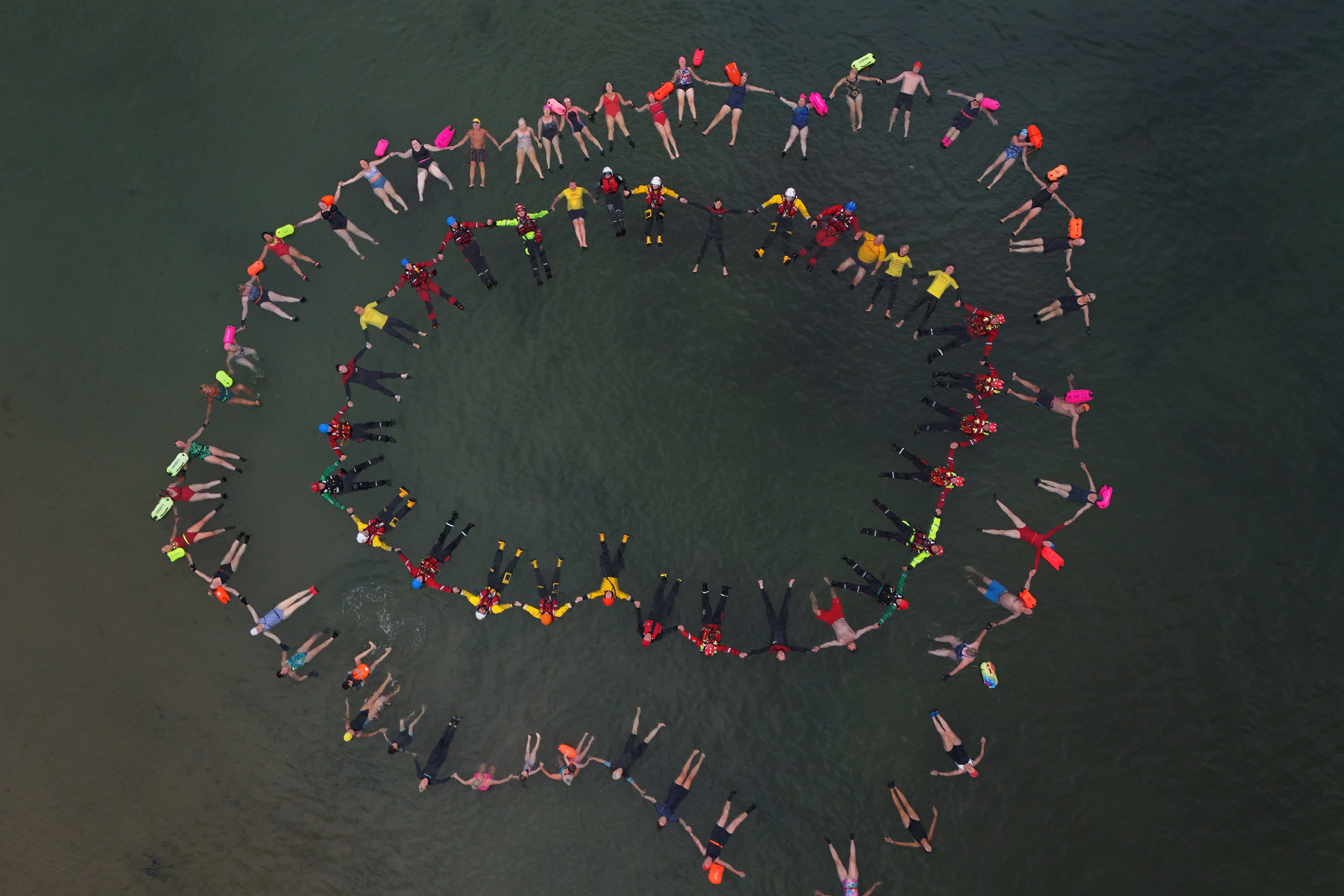 Life-saving organisations and emergency services joined to make a Circle of Life at Cullercoats Bay, North Tyneside, to highlight the Float to Live technique (Owen Humphreys/PA)