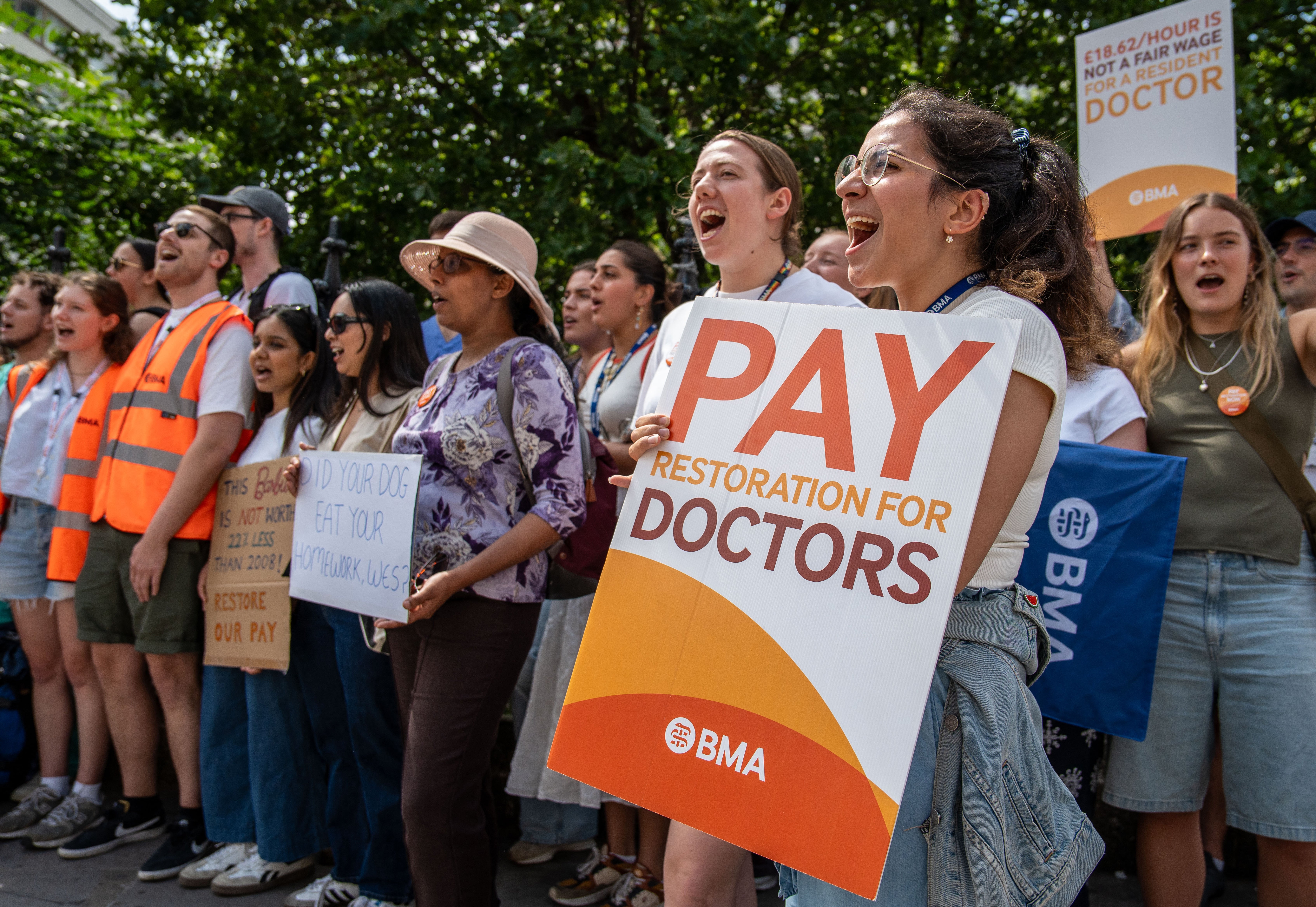 Staff hold placards as they stand on a picket line on the first day of a resident doctors' strike outside St Thomas' Hospital, in central London, in July 2025