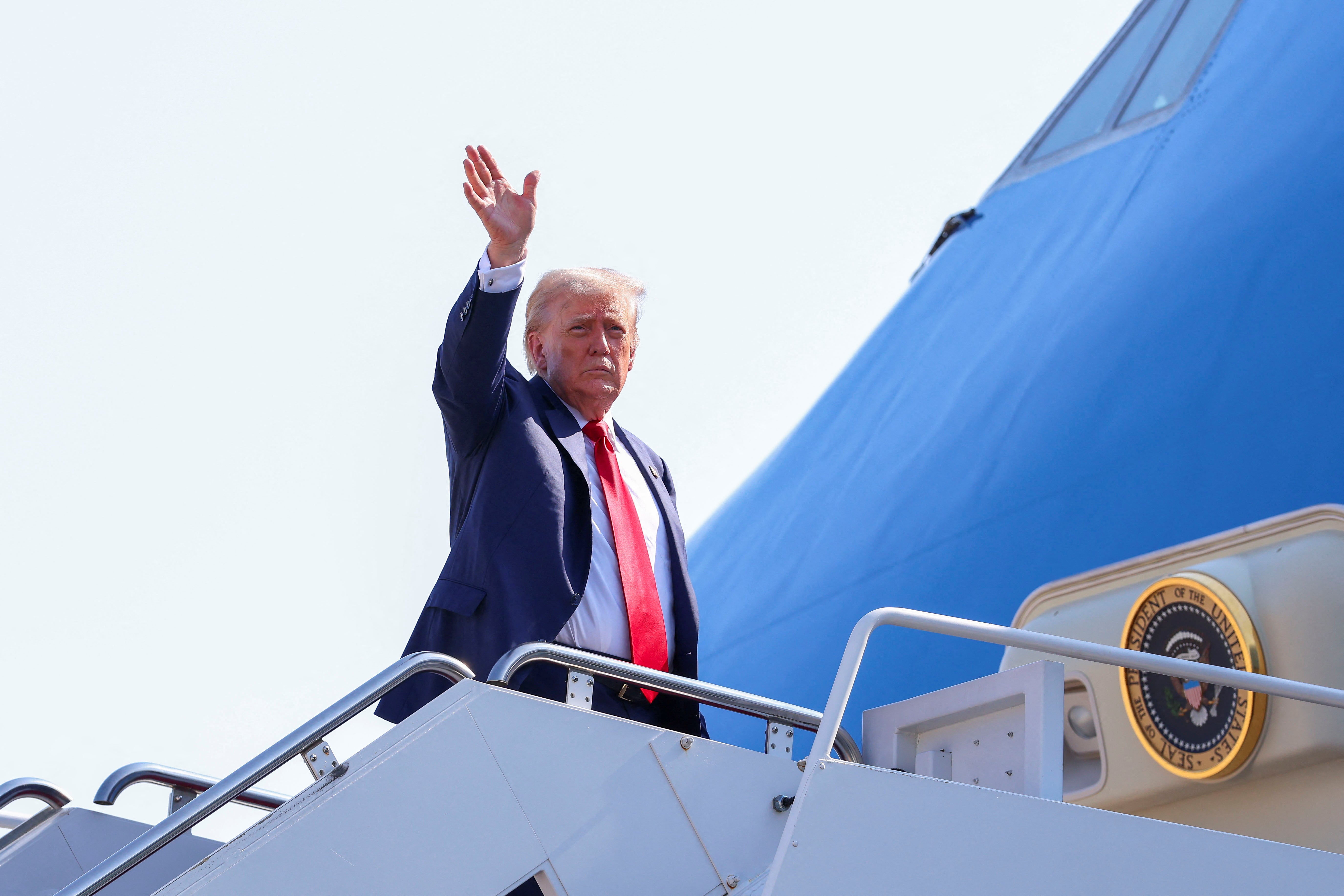 Trump waved as he boarded Air Force One on Friday, as he departed for Scotland, at Joint Base Andrews