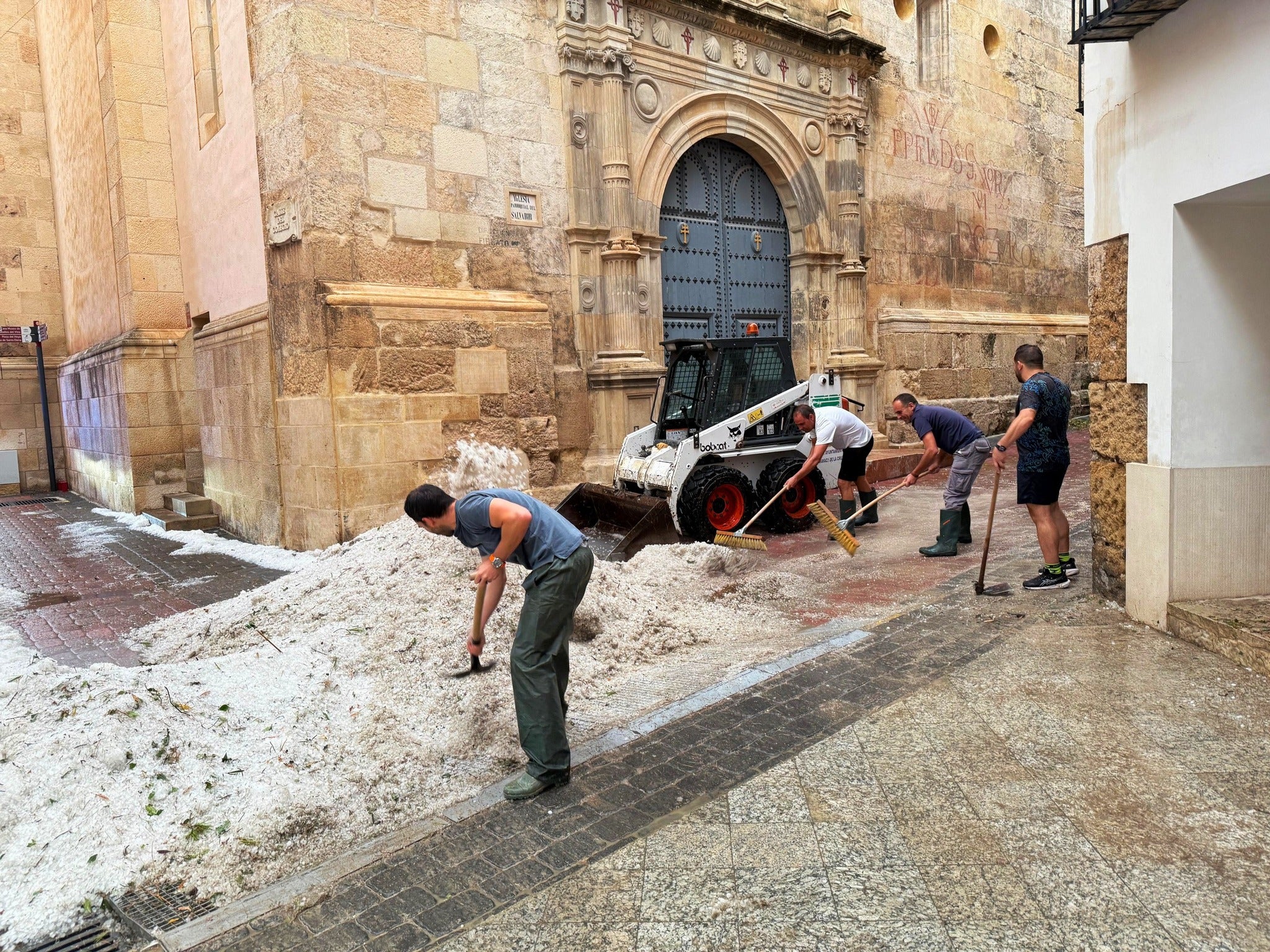 Thick layers of hail piled up on pavements and roads in the town