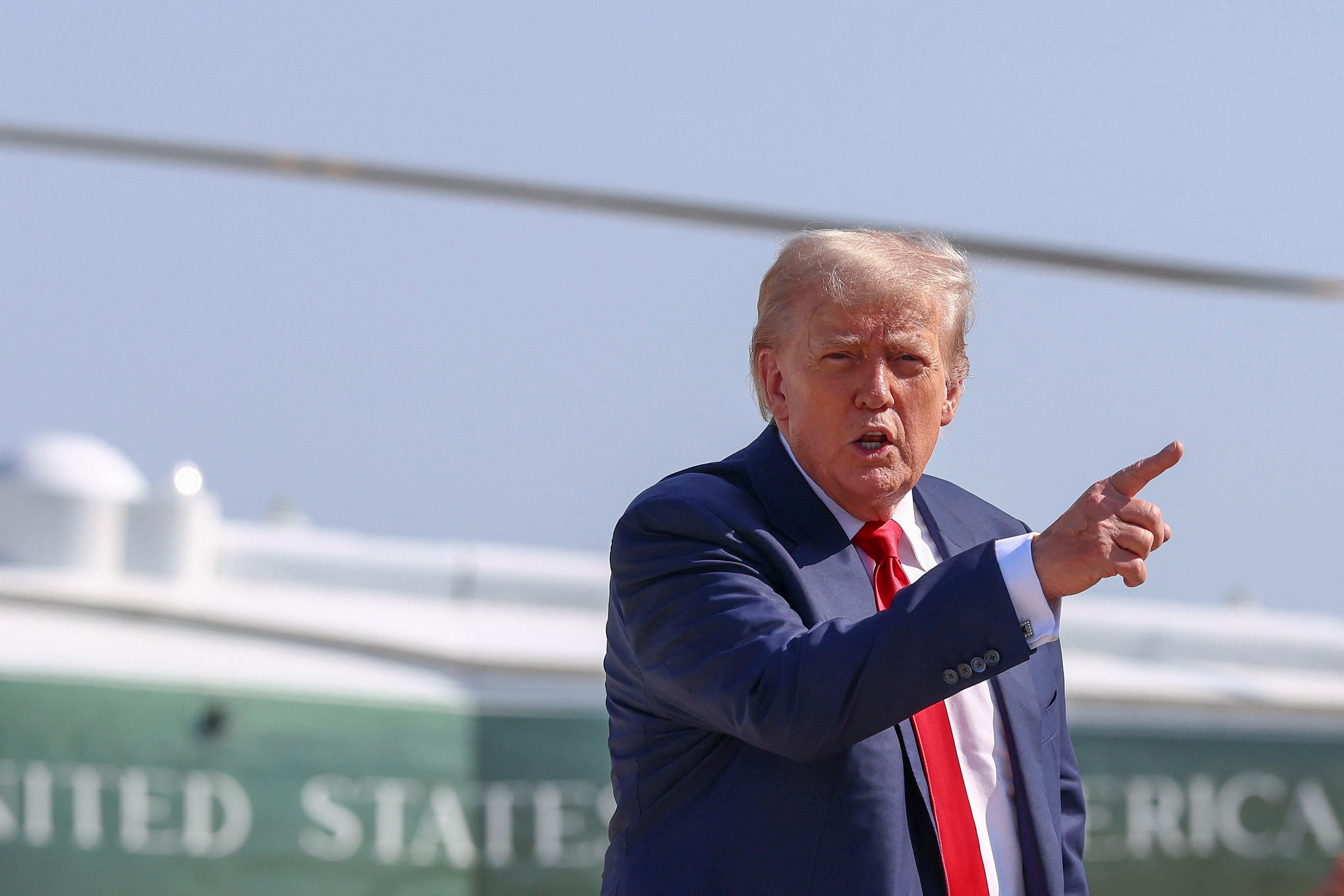 U.S. President Donald Trump gestures after disembarking Marine One, as he departs for Scotland, at Joint Base Andrews, Maryland, U.S., July 25, 2025