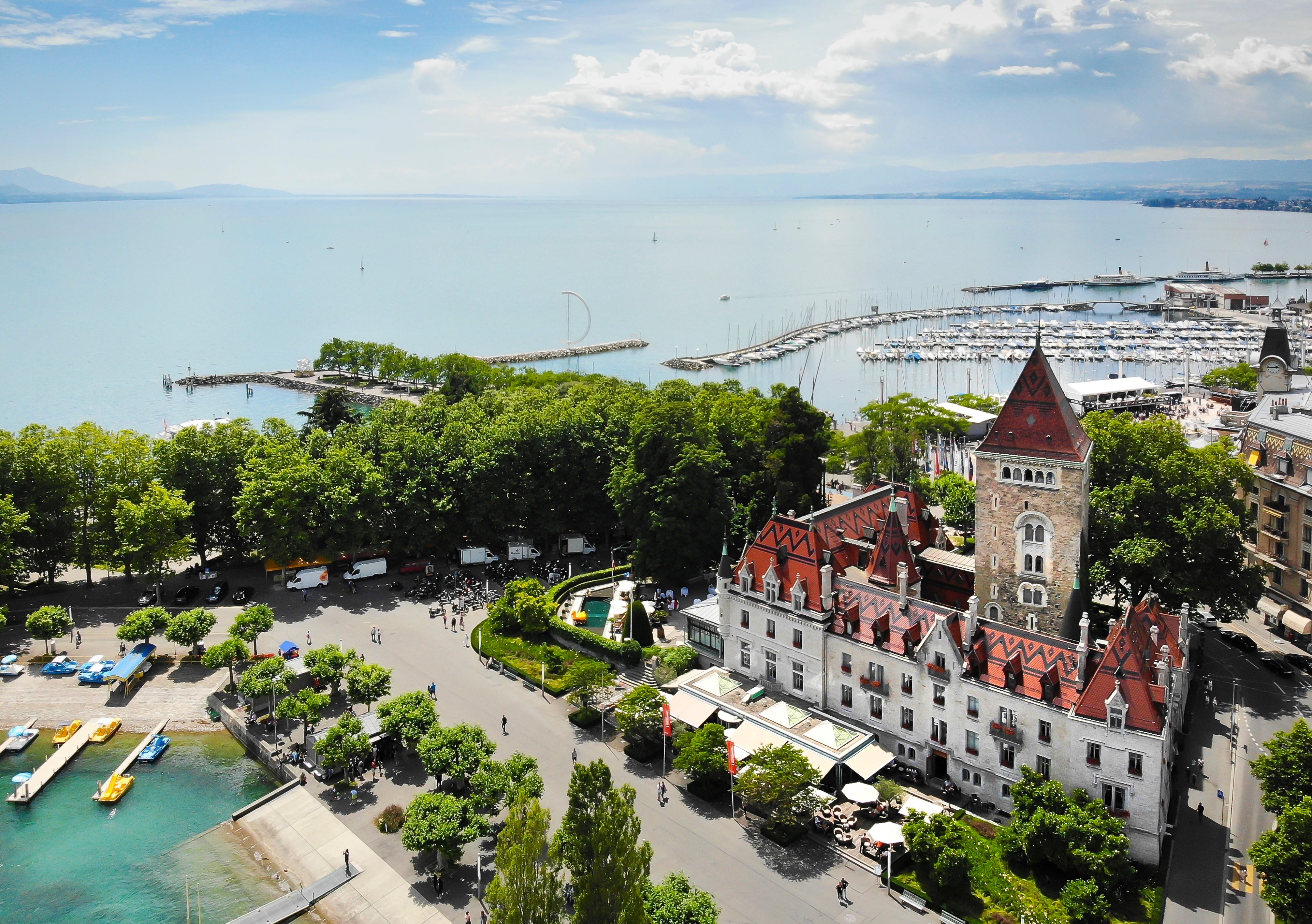 Chateau d'Ouchy stands proud on the banks of Lake Geneva like a pop-up storybook castle