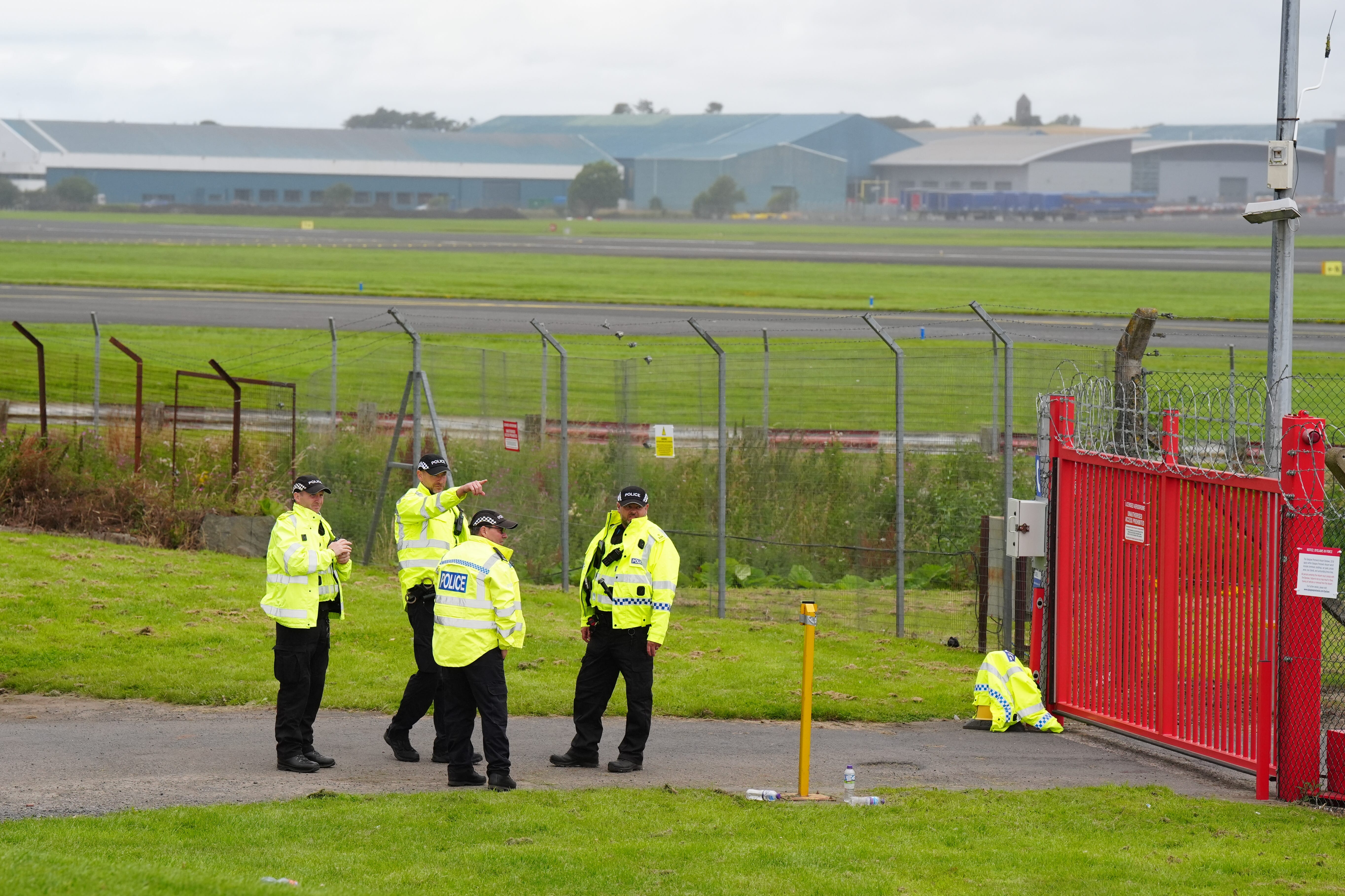 Police outside the perimeter of Prestwick Airport ahead of the arrival of US President Donald Trump (Jane Barlow/PA)