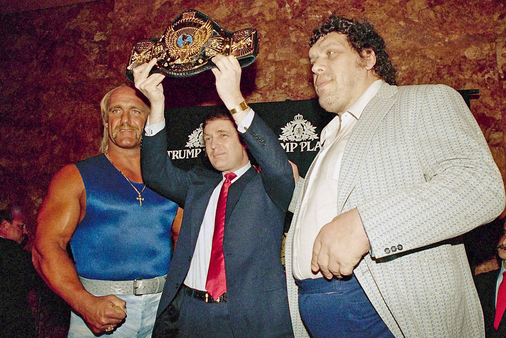 Trump poses with Hulk Hogan (left) and André the Giant (right) at the 1987 WrestleMania