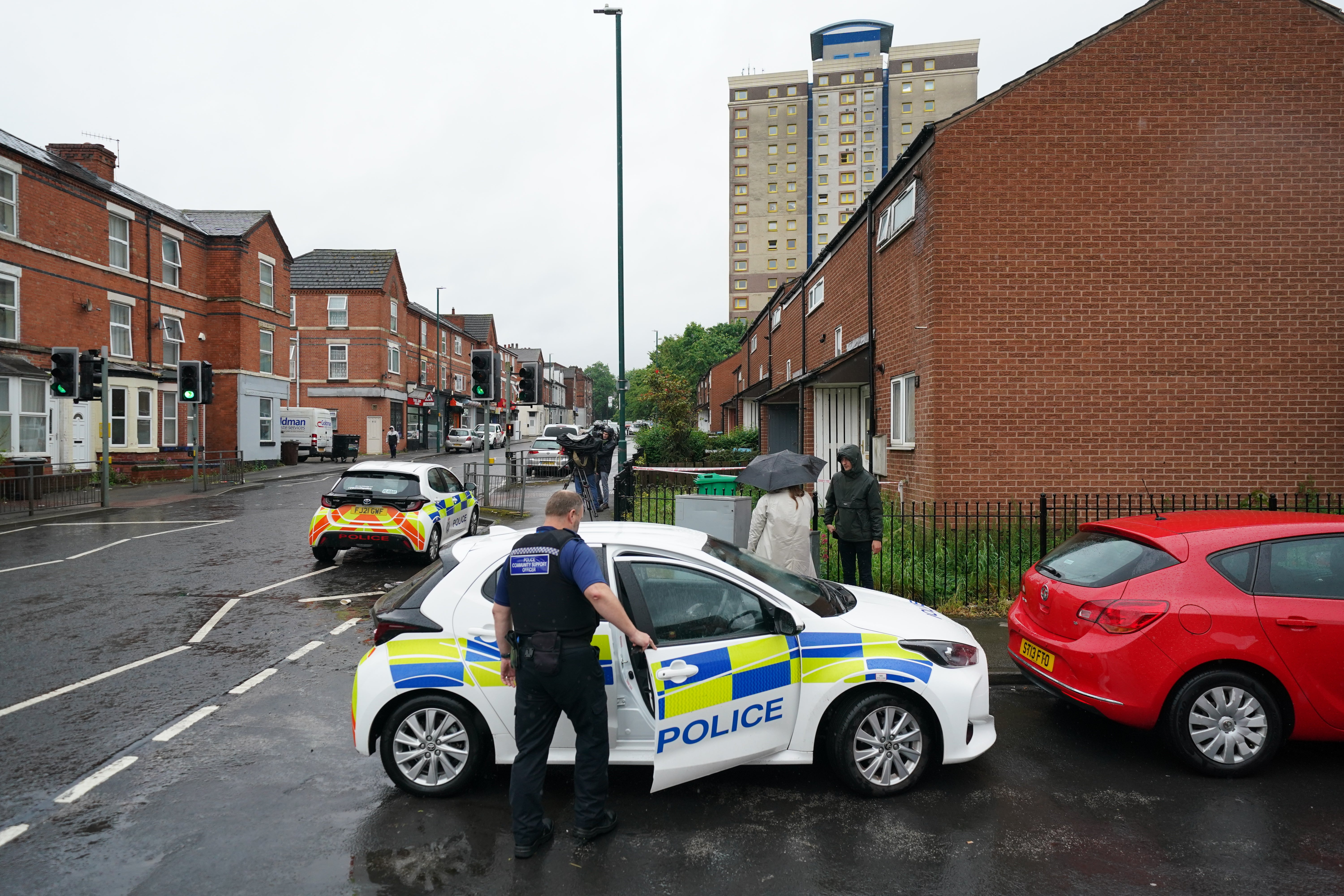 Police at the scene a day after the bodies were found