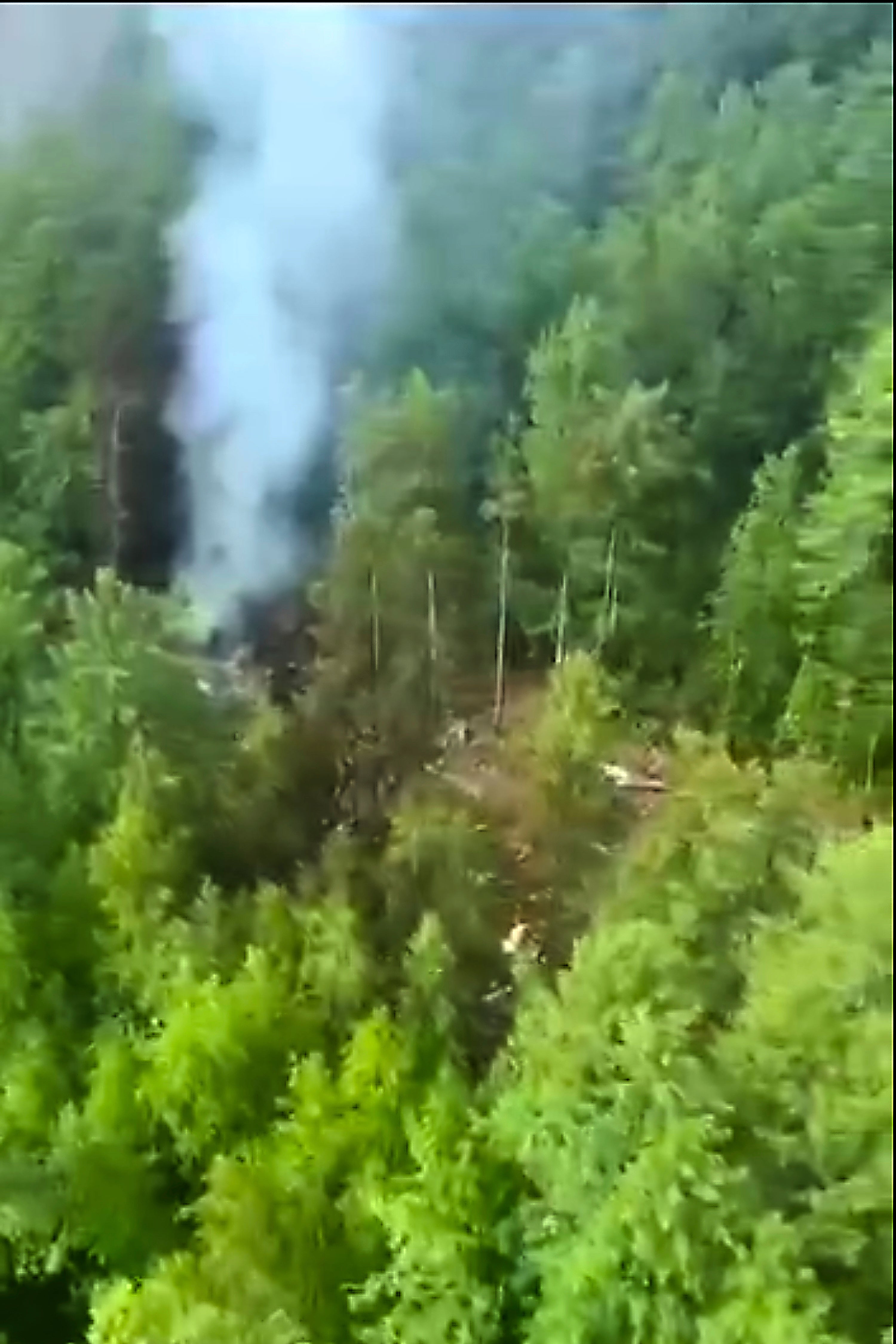 Smoke rises from the crash site of a Russian An-24 passenger plane of the Siberia-based Angara Airlines about 15km south of Tynda